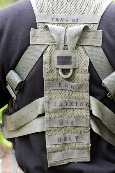 Capt. Zachary Minner, 40th Helicopter Squadron UH-1N Huey pilot, dons a training vest during combat survival skill training in Monarch, Mont., on June 11. Eight Airmen endured survival, evasion, resistance and escape training in the Lewis and Clark National Forest as part of their three-year requirement to maintain combat mission-ready status. (U.S. Air Force photo/Senior Airman Katrina Heikkinen)