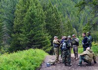 Aircrew members of the 40th Helicopter Squadron, and 341st Security Forces Group Tactical Response Force Nuclear Advanced Designated Marksmen rally before starting a field training exercise in Monarch, Mont., as part of a survival, evasion, resistance and escape training. Aircrew members are required to complete SERE training every three years as part of their combat mission-ready status. (U.S. Air Force photo/Senior Airman Katrina Heikkinen)