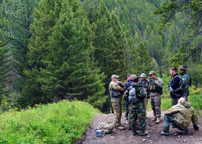 Aircrew members of the 40th Helicopter Squadron, and 341st Security Forces Group Tactical Response Force Nuclear Advanced Designated Marksmen rally before starting a field training exercise in Monarch, Mont., as part of a survival, evasion, resistance and escape training. Aircrew members are required to complete SERE training every three years as part of their combat mission-ready status. (U.S. Air Force photo/Senior Airman Katrina Heikkinen)