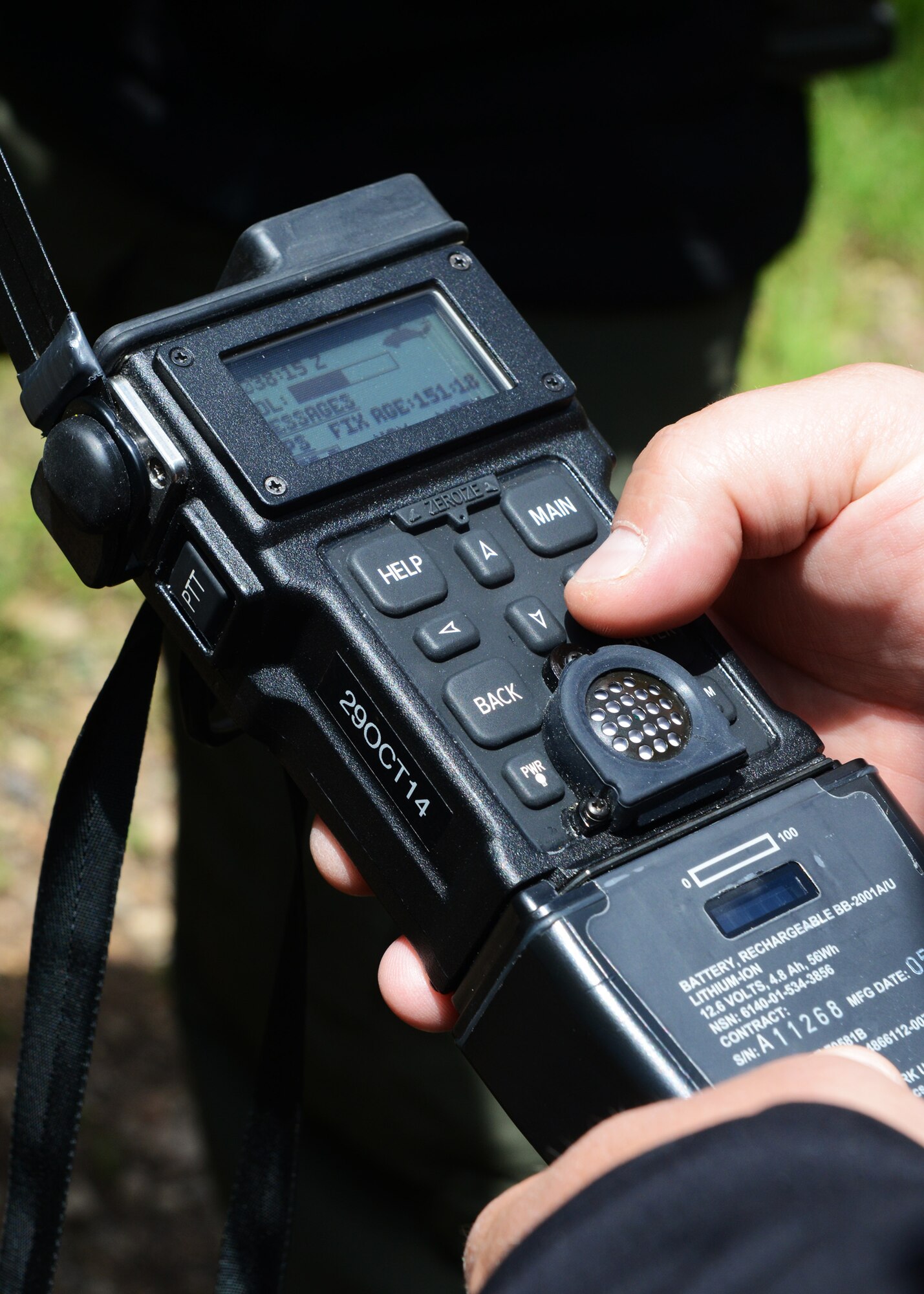 A close-up shows Corey Ask, Air Force Global Strike Command contracted survival, evasion, resistance and escape program analyst, teaching Airmen how to use a combat survival evader locator radio during a field training exercise in Monarch, Mont. The FTX was part of a week-long SERE training, which is a three-year requirement for all aircrew members. (U.S. Air Force photo/Senior Airman Katrina Heikkinen)