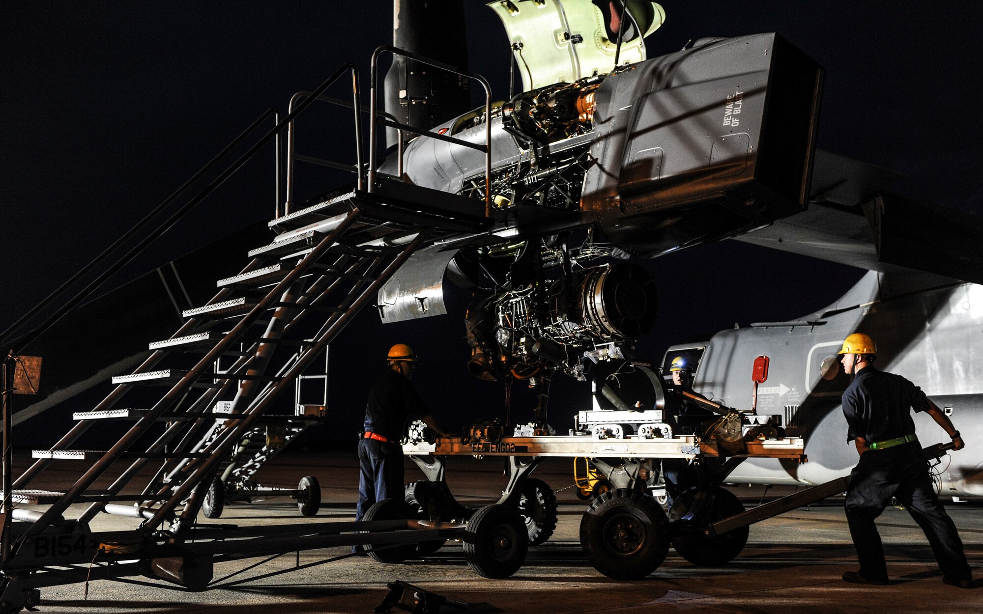 Airmen from the 801st Special Operations Aircraft Maintenance Squadron move a rack under a CV-22 Osprey during maintenance on Hurlburt Field, Fla., June 13, 2014. The Airmen removed the engine to further inspect and fix issues with the parts. (U.S. Air Force photo/Senior Airman Christopher Callaway) 