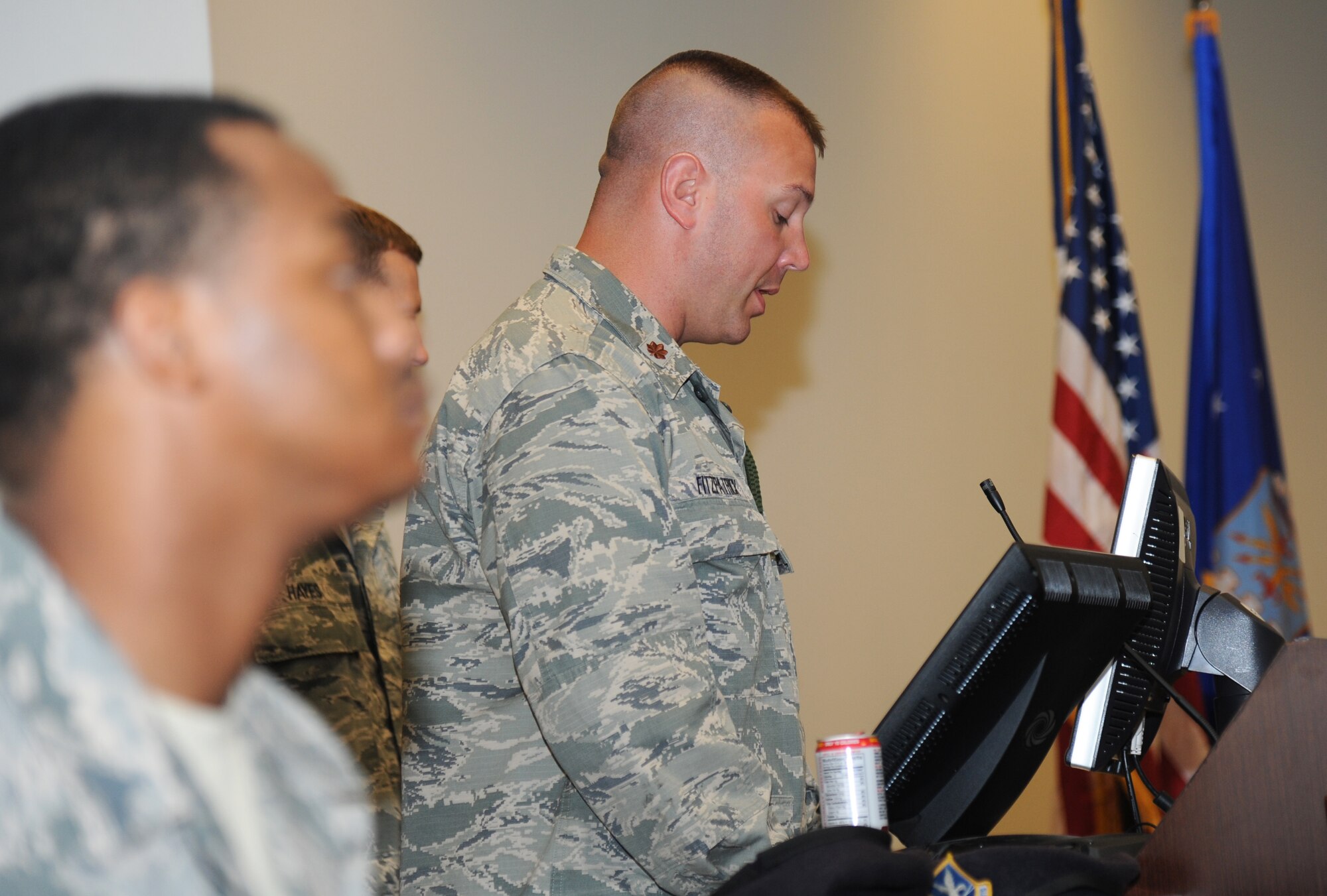 Maj. Brian Fitzpatrick, 81st Security Forces commander, delivers remarks during the retirement ceremony of military working dog, Gino, June 12, 2014, at the Roberts Consolidated Maintenance Facility, Keesler Air Force Base, Miss.  Gino is eleven years old and served nine years of military service to the Air Force. (U.S. Air Force photo by Kemberly Groue)