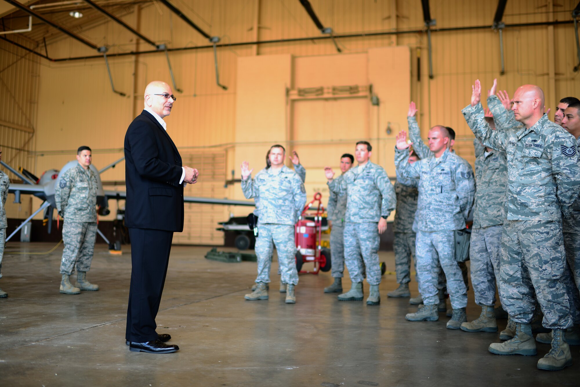 Maintainers raise their hands as John Johns, Deputy Assistant Secretary of Defense for maintenance policy and programs, asks who was working with the unit in 2012, the year that the 27th Special Operations Maintenance Group was recognized for outstanding performance. Johns visited the base to congratulate the 27 SOMXG on receiving the Secretary of Defense Field Level Maintenance Excellence Award. (U.S. Air Force photo/Airman 1st Class Shelby Kay-Fantozzi) 