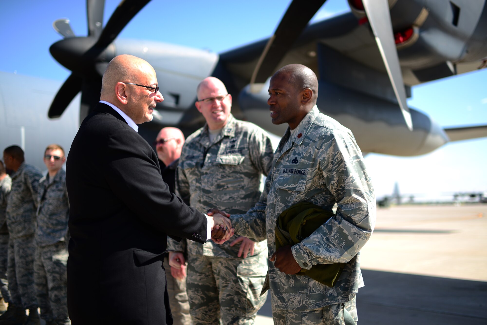 John Johns, Deputy Assistant Secretary of Defense for maintenance policy and programs, exchanges coins with U.S. Air Force Maj. Ahave Brown, 27th Special Operations Aircraft Maintenance Squadron commander. Johns visited the base to congratulate the 27th Special Operations Maintenance Group on receiving the Secretary of Defense Field Level Maintenance Excellence Award. (U.S. Air Force photo/Airman 1st Class Shelby Kay-Fantozzi) 