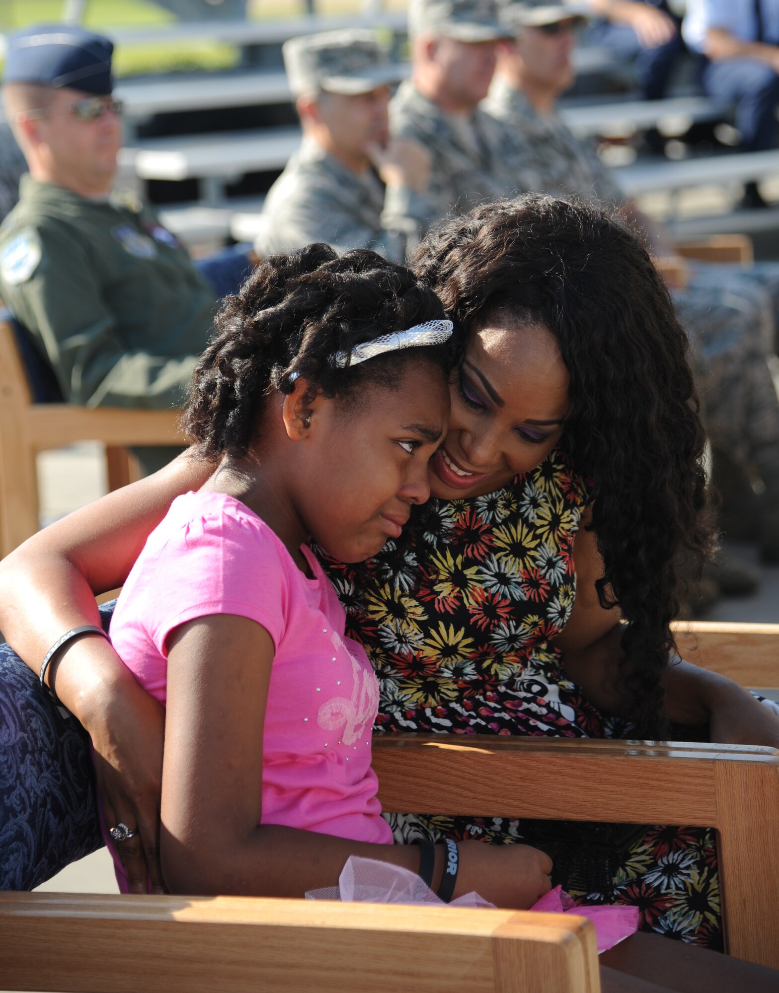 Carmen Holt is comforted by her mother, Patricia Holt, during a re-dedication ceremony honoring Carmen’s father, the late Airman 1st Class Antoine Holt, June 12, 2014, in front of Avery Manor at Keesler Air Force Base, Miss.  Holt, a former student in the 334th TRS, lost his life April 10, 2004 while at Balad Air Base, Iraq, when his tent was hit by a mortar attack. (U.S. Air Force photo by Kemberly Groue)