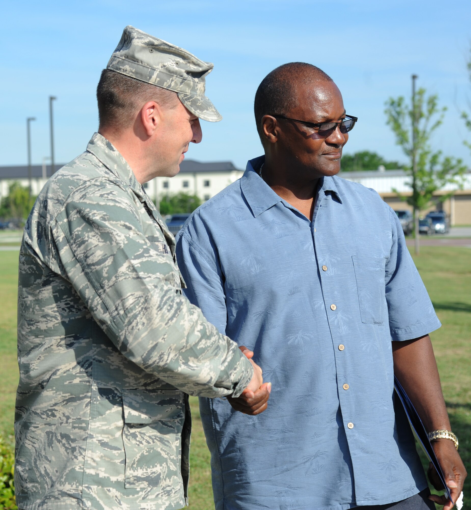 Brig. Gen. Patrick Higby, 81st Training Wing commander, shakes the hand of Michael Holt, the father of the late Airman 1st Class Antoine Holt following the unveiling of a memorial honoring Airman Holt during a re-dedication ceremony June 12, 2014, in front of Avery Manor at Keesler Air Force Base, Miss.  Holt, a former student in the 334th TRS, lost his life April 10, 2004 while at Balad Air Base, Iraq, when his tent was hit by a mortar attack.  (U.S. Air Force photo by Kemberly Groue)