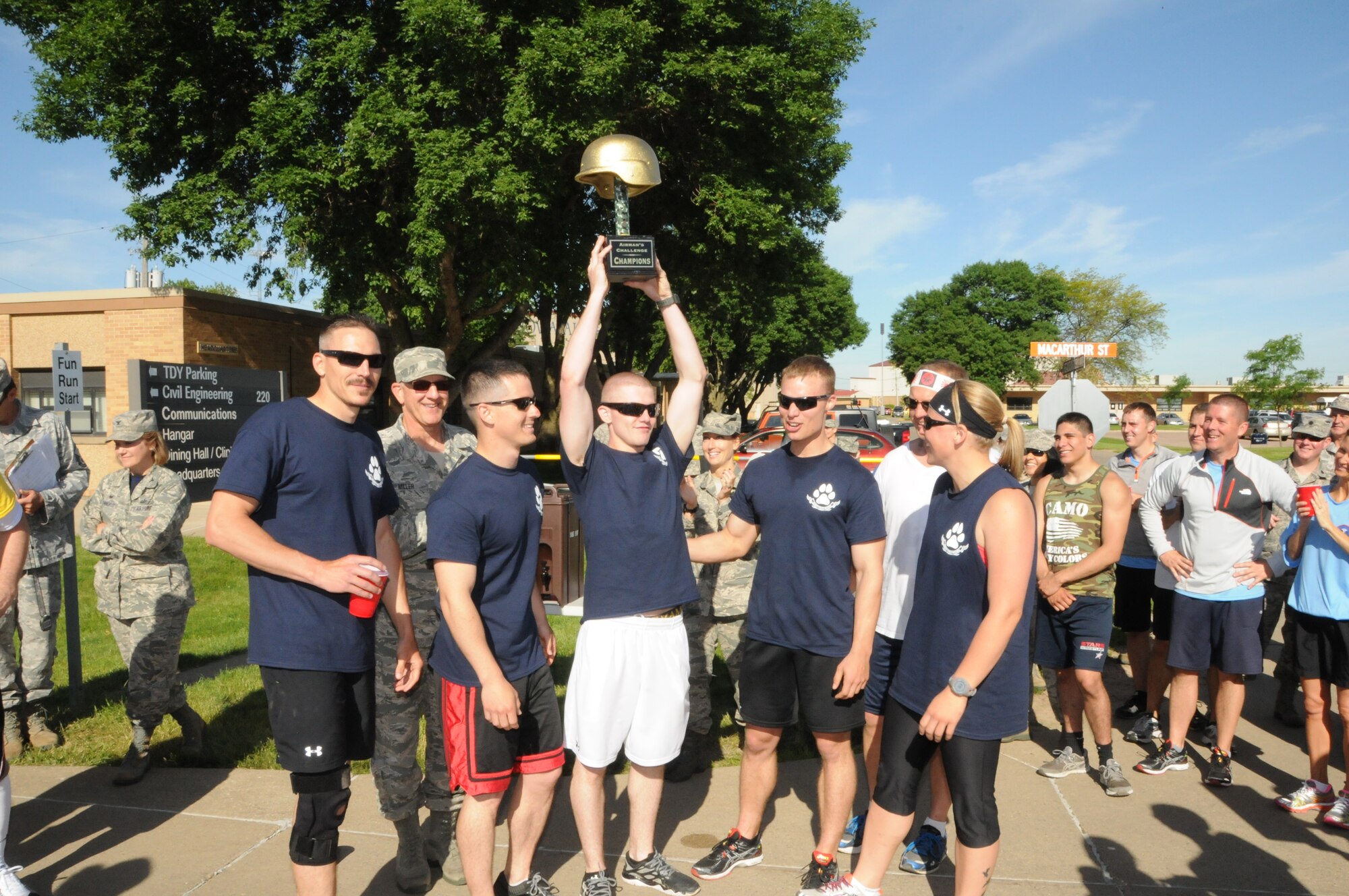 Members of the "Sheep Dogs" accept the trophy for winning the Fitness Challenge held at the airbase on June 13, 2014. The callenge consisted of various stations to test their fitness over a 1.5 mile course. (U.S. Air National Guard photo by 1st Lt. Jeremy J. McClure/Released)