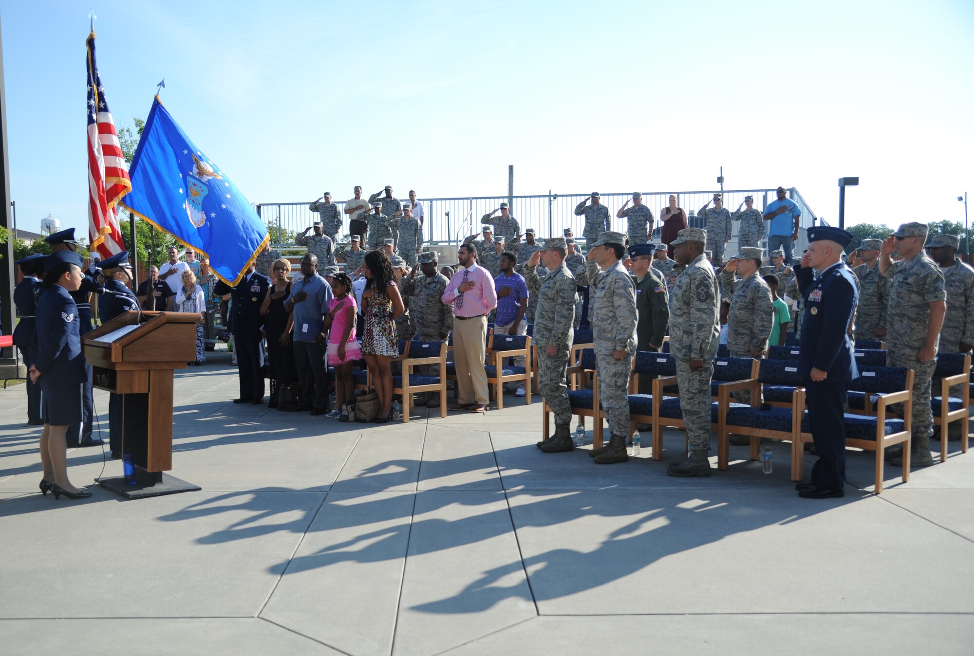 Airmen and Keesler personnel render a salute while the National Anthem was sung during a re-dedication ceremony honoring the late Airman 1st Class Antoine Holt June 12, 2014, in front of Avery Manor at Keesler Air Force Base, Miss.  Holt, a former student in the 334th TRS, lost his life April 10, 2004 while at Balad Air Base, Iraq, when his tent was hit by a mortar attack.  (U.S. Air Force photo by Kemberly Groue)