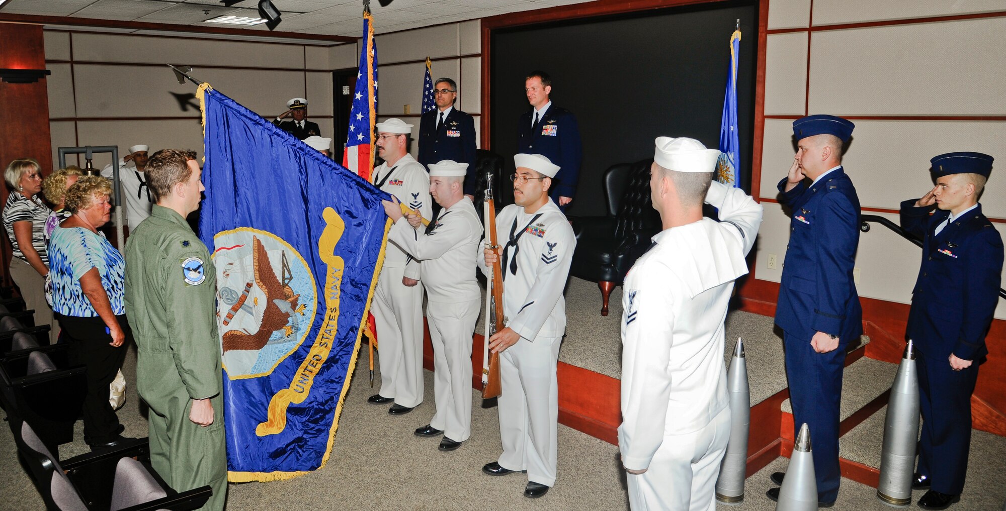 U.S. Navy Honor Guard from the Navy Operational Support Center present colors at a retirement ceremony June 12, 2014, at McConnell Air Force Base, Kan. They honored Air Force Capt. Jason Scoggins, 22nd Air Refueling Squadron navigator, who retired after more than 17 years of service. Scoggins served his first nine years as an enlisted sailor. (U.S. Air Force photo/Airman 1st Class John Linzmeier)