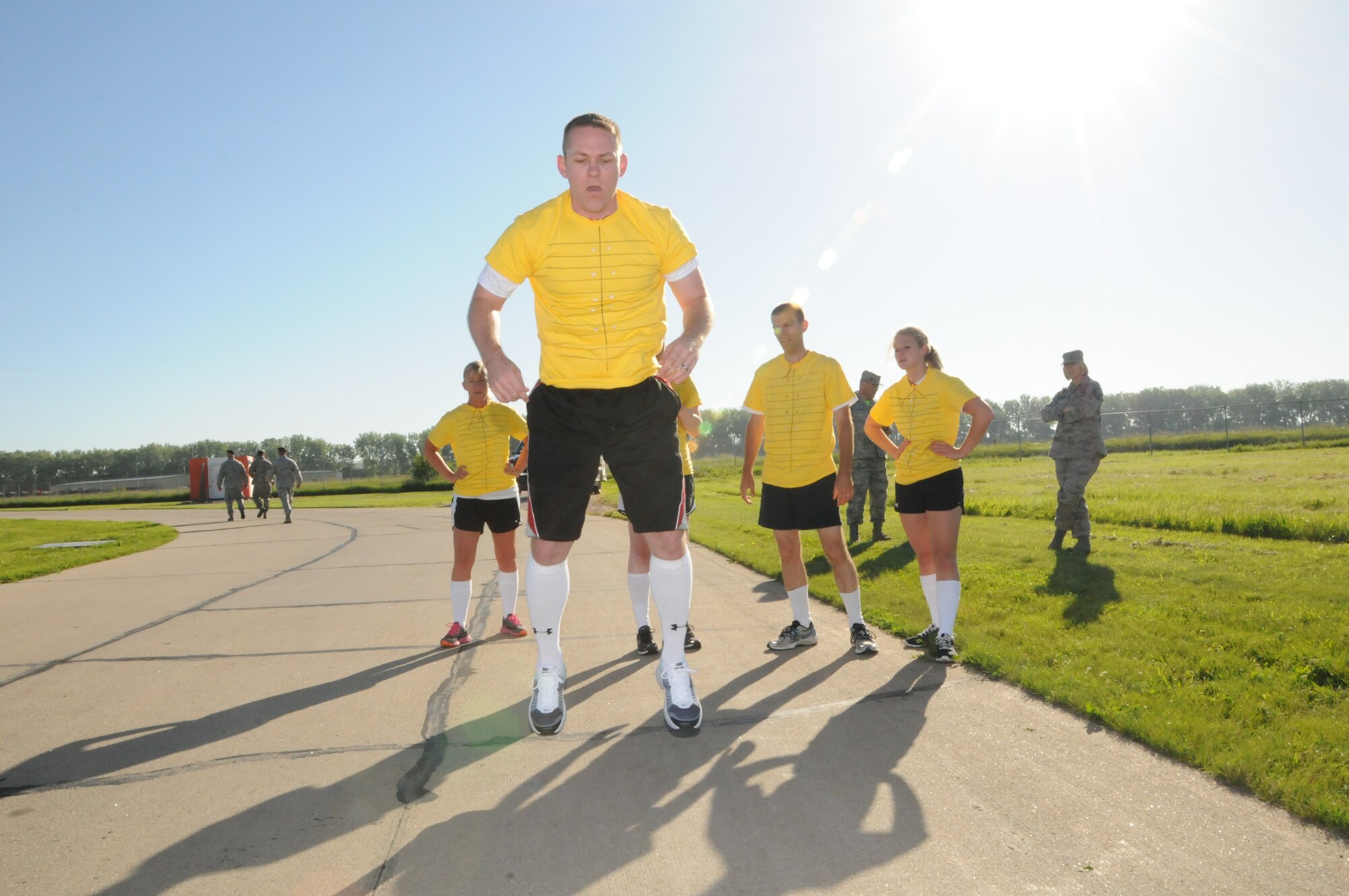 Members of the "Holey Joes" catch their breath while their team mate knocks out some "burpees" during the Fitness Challenge held at the airbase on June 13, 2014. (U.S. Air National Guard photo by 1st Lt. Jeremy J. McClure/Released)