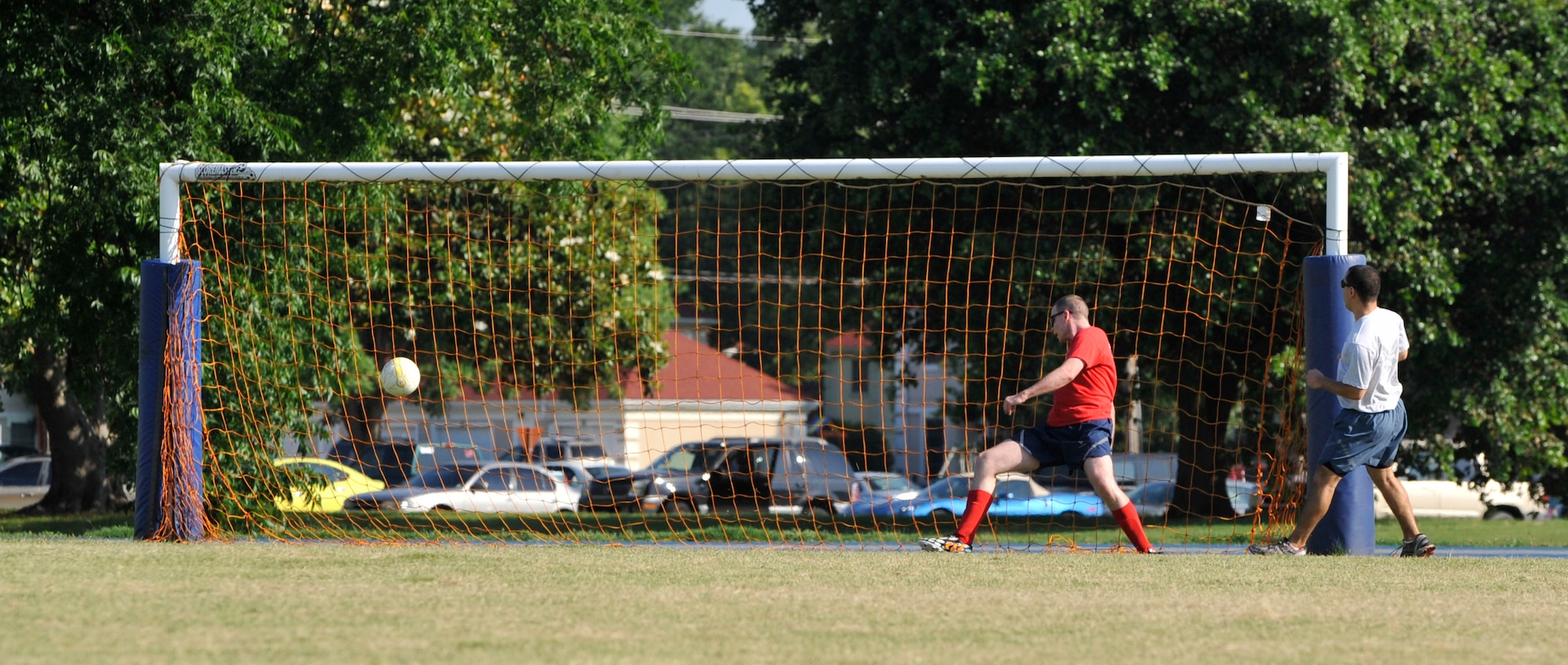 A 2nd Operations Support Squadron Airman scores a goal against the 2nd Force Support Squadron during a Sports Day soccer game on Barksdale Air Force Base, La., June 13, 2014. The soccer game followed a 5K fun run and a series of other sports in order to promote fitness and teamwork. (U.S. Air Force photo/Airman 1st Class Benjamin Raughton)