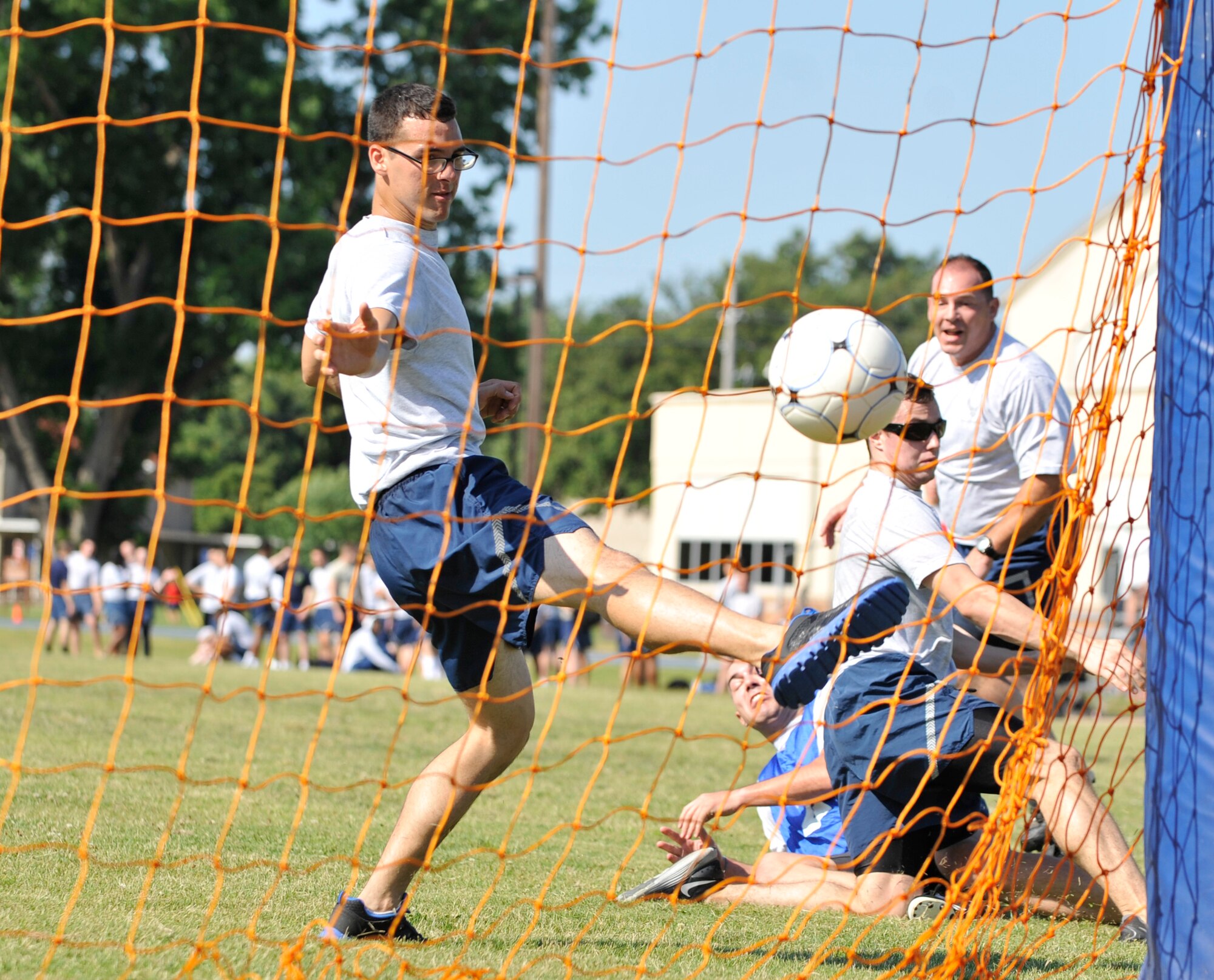 An Airman from the 608th Air Communication Squadron scores a goal against the 2nd Medical Support Squadron during a Sports Day soccer game on Barksdale Air Force Base, La., June 13, 2014. Sports Day is comprised of various competitive athletic events to help promote physical fitness. (U.S. Air Force photo/Airman 1st Class Benjamin Raughton)