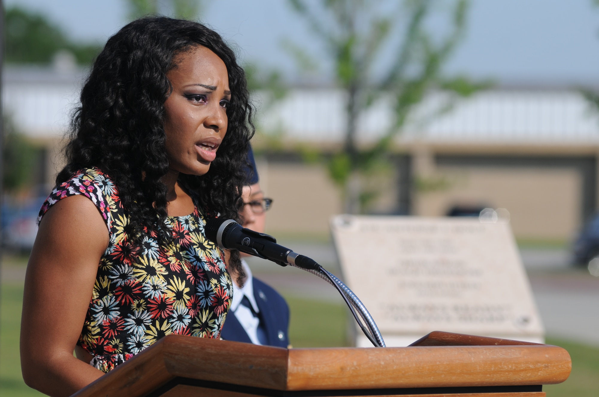 Patricia Holt, the wife of the late Airman 1st Class Antoine Holt, makes remarks during a re-dedication ceremony to honor Holt with a memorial June 12, 2014, in front of Avery Manor at Keesler Air Force Base, Miss.  Holt, a former student in the 334th Training Squadron, lost his life April 10, 2004 while at Balad Air Base, Iraq, when his tent was hit by a mortar attack  (U.S. Air Force photo by Kemberly Groue)