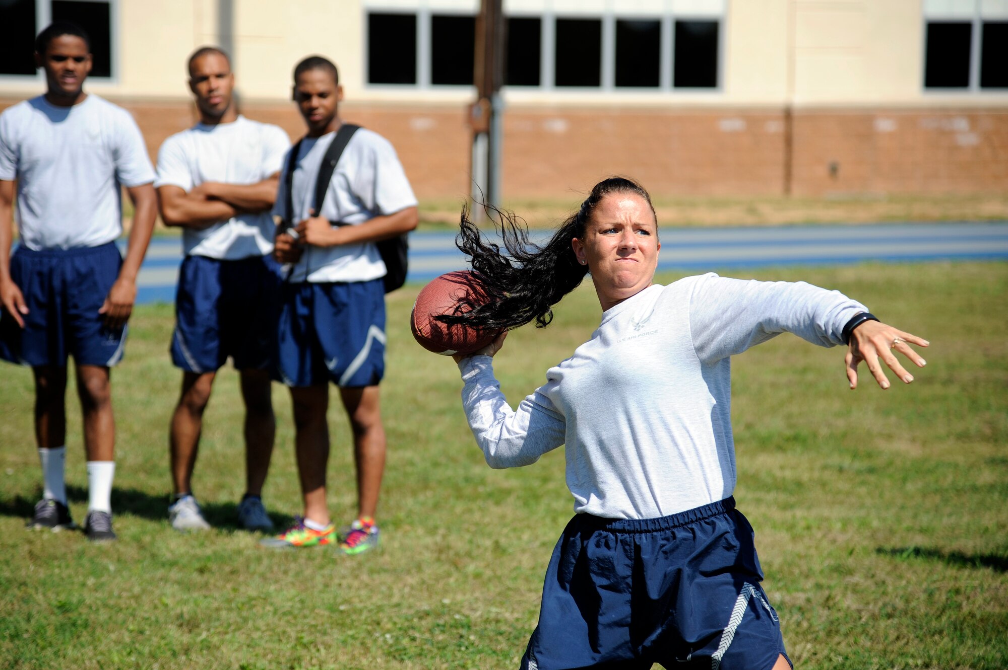 An Airman with the 2nd Civil Engineer Squadron prepares to throw a football during the Quarterback Skills competition as part of Sports Day at Barksdale Air Force Base, La., June 13, 2014. Sports Day is an annual event that gives Airmen the opportunity to participate in several individual and team sports to boost morale and camaraderie. (U.S. Air Force photo/Tech. Sgt. Marie Brown)
