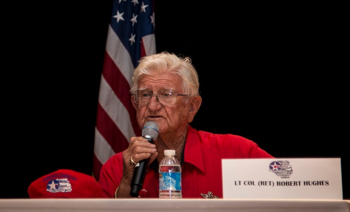 Retired Lt. Col. Robert Hughes, an original Tuskegee Airman instructor, speaks to a crowd of students and service members June 12, 2014, at the Base Theater on Joint Base Charleston, S.C. Hughes told stories of his past to students from the Take Flight! Aviation Camp where they learned the history of the Tuskegee Airmen. (U.S. Air Force photo/ Airman 1st Class Clayton Cupit)