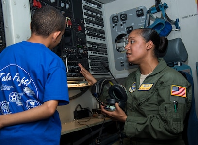 Senior Airman Janisa Reeves, 16th Airlift Squadron loadmaster, explains to a student how voice communication works on a C-17 Globemaster III, June 12, 2014, at Joint Base Charleston, S.C. Students from the Take Flight! Aviation Camp got an inside look at one of JB Charleston’s C-17’s and also got to hear stories from retired Lt. Col. Robert Hughes, an original Tuskegee Airman. (U.S. Air Force photo/ Airman 1st Class Clayton Cupit)