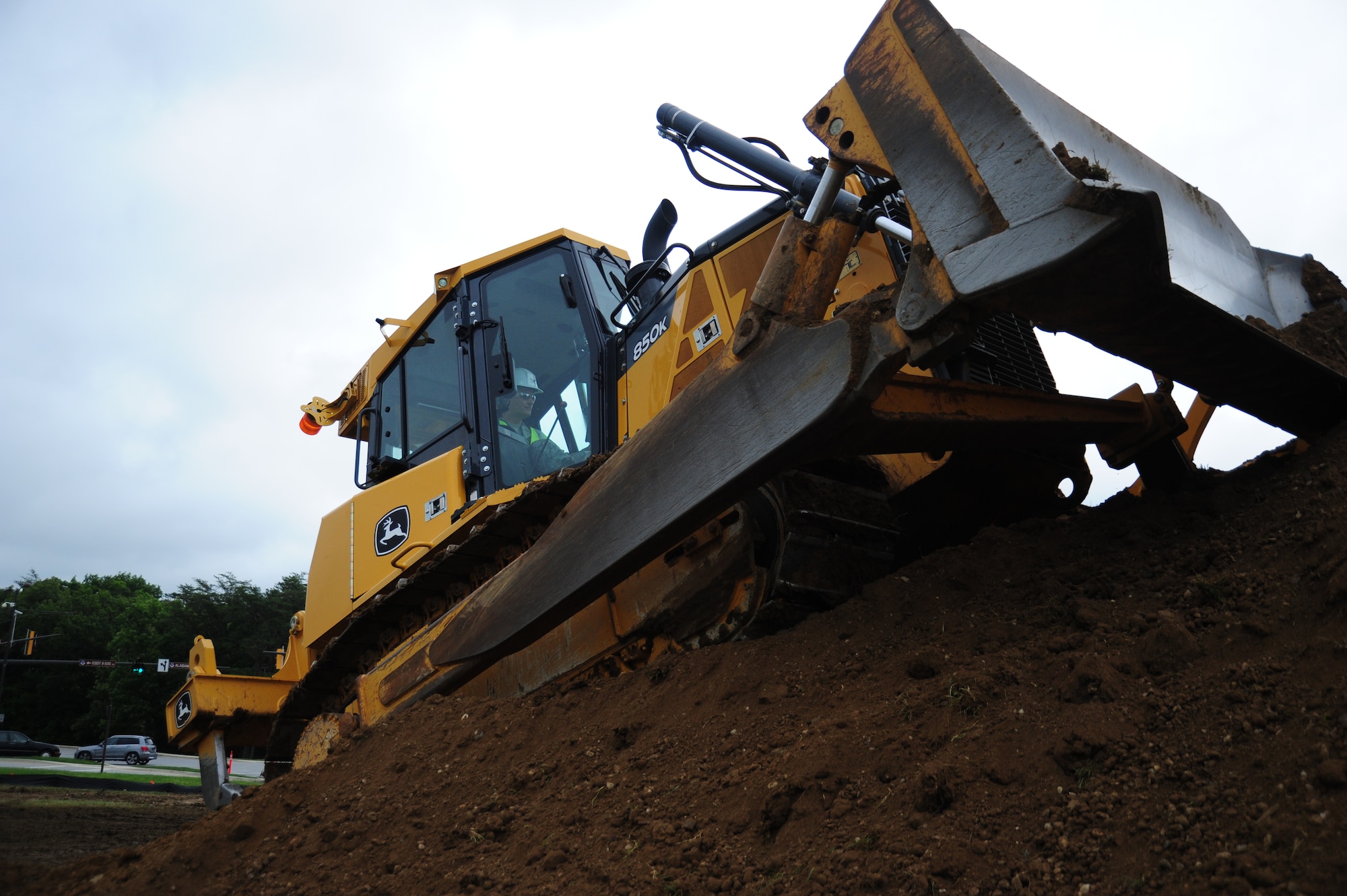 Col. Bill Knight, 11th Wing/Joint Base Andrews commander, operates a construction vehicle at the site currently in development for Heritage Park near the main entrance at Joint Base Andrews, Md., June 5, 2014. The park will display a grass field and static displays of military aircrafts when construction is complete. (U. S. Air Force photo/Airman 1st Class Joshua R. M. Dewberry) 