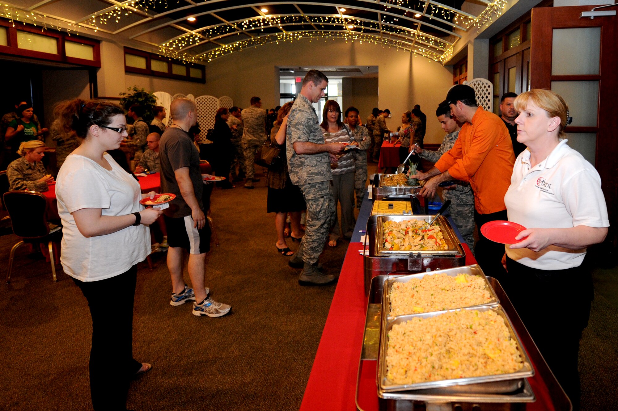 Chefs from the Chisholm Trail Inn Dining Facility face-off against chefs from Taste and See, June 12, 2014, at McConnell Air Force Base, Kan. Three to four personnel from the DFAC went head-to-head against the Taste and See head chef Jason Febres, preparing three different entrees for judges and a crowd of on-lookers. Each culinary team presented their own original take on similar dishes for judges to decide who made it the best, and the crowd voted on the ‘people’s favorite’. Taste and See chef’s came out victorious in the end, but the DFAC team laid claim to the people’s favorite. (U.S. Air Force photo/Airman 1st Class Aaron-Forrest Wainwright)