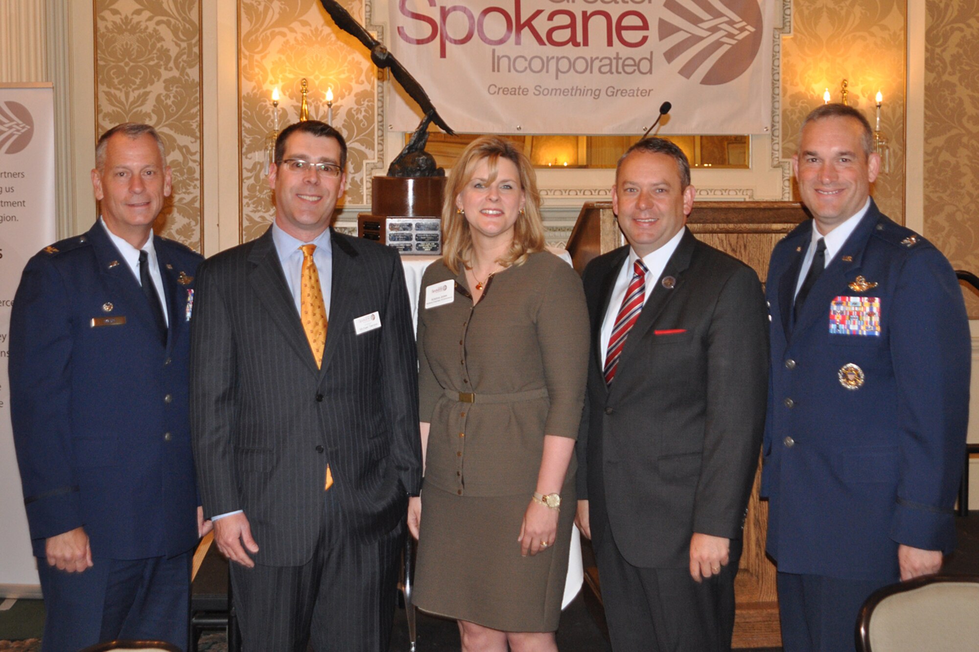 Col. Daniel Swain, Michael Senske, Kristina Jones, Mayor David Condon and Col. Brian Newberry pose for a photo during the Greater Spokane Incorporated breakfast at Spokane, Wash., June 13, 2014. The 2013 Abilene trophy was presented to the city of Spokane for outstanding support to Air Mobility Command base. Swain is the 141st Air Refueling Wing commander, Senske is the GSI chairman of the board, Jones is the Abilene trophy executive board member, Condon is the Mayor of Spokane and Newberry is the 92nd ARW commander. (U.S. Air Force photo by Scott King/Released)
