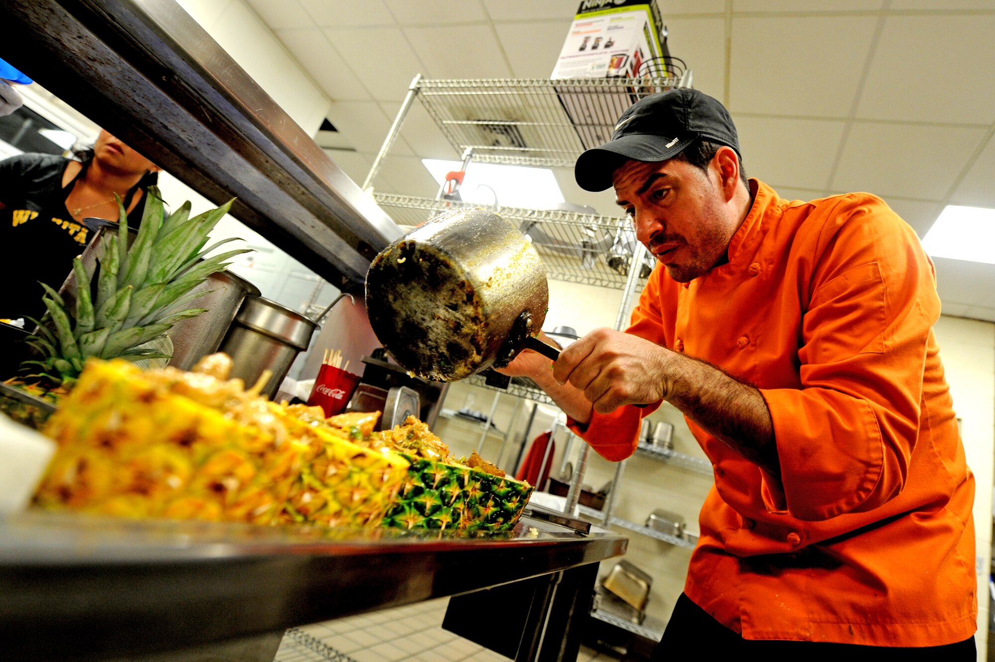 Chefs from the Chisholm Trail Inn Dining Facility face-off against chefs from Taste and See, June 12, 2014, at McConnell Air Force Base, Kan. Three to four personnel from the DFAC went head-to-head against the Taste and See head chef Jason Febres, preparing three different entrees for judges and a crowd of on-lookers. Each culinary team presented their own original take on similar dishes for judges to decide who made it the best, and the crowd voted on the ‘people’s favorite’. Taste and See chef’s came out victorious in the end, but the DFAC team laid claim to the people’s favorite. (U.S. Air Force photo/Airman 1st Class Aaron-Forrest Wainwright)