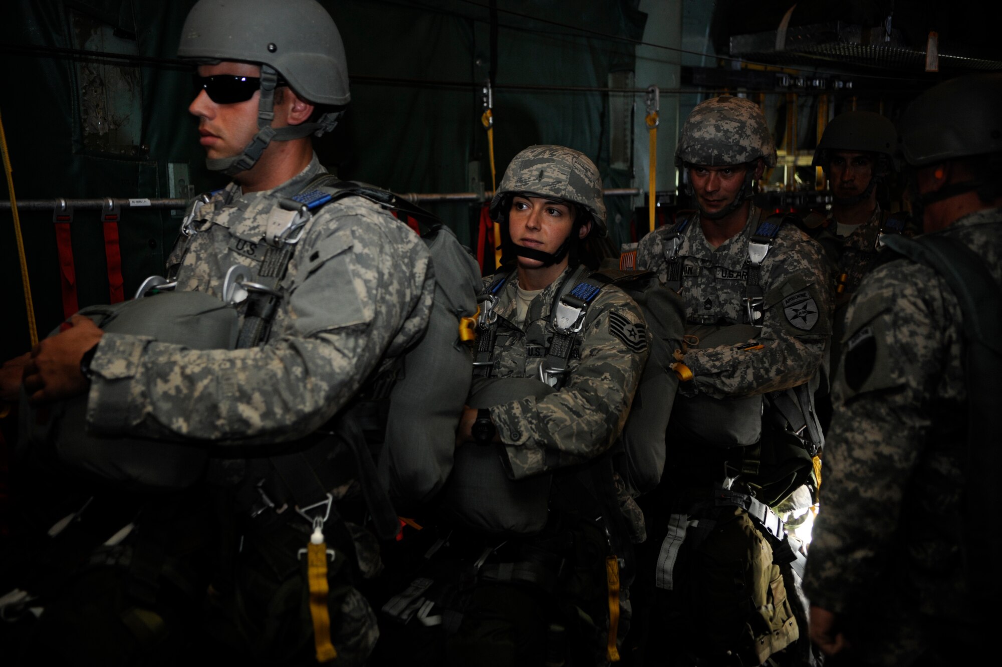 (Left and Middle) Staff Sgt. Christopher Bitwinski, Special Operations Command operational NCO, and Tech. Sgt. Veronica Gatta, Joint Communications Support Element Direct Communications Support team chief, wait to be given the green light to get into position to jump May 21, 2014. JCSE personnel jump from various aircraft in small communication packages that provide task force commanders secure voice and data communications on the drop zone within minutes of hitting the ground. (U.S. Air Force photo by Senior Airman Vernon L. Fowler Jr. /Released)