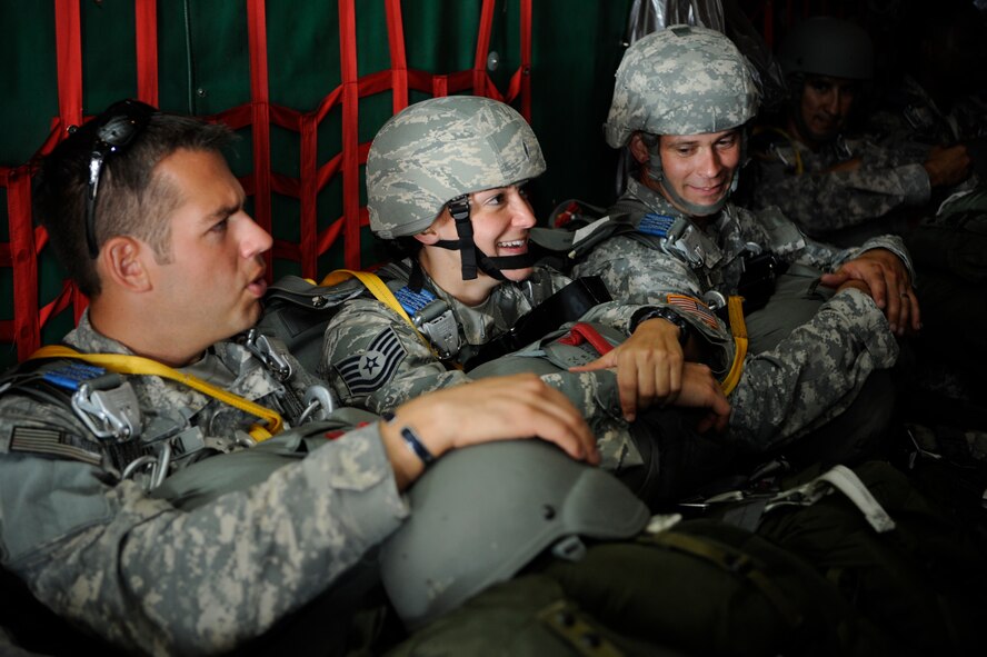 (Left and Middle) Staff Sgt. Christopher Bitwinski, Special Operations Command operational NCO, and Tech. Sgt. Veronica Gatta, Joint Communications Support Element Direct Communications Support team chief, await take-off May 21, 2014 at MacDill Air Force Base, Florida. JCSE personnel jump from various aircraft in small communication packages that provide task force commanders secure voice and data communications on the drop zone within minutes of hitting the ground. (U.S. Air Force photo/Senior Airman Vernon L. Fowler Jr.)