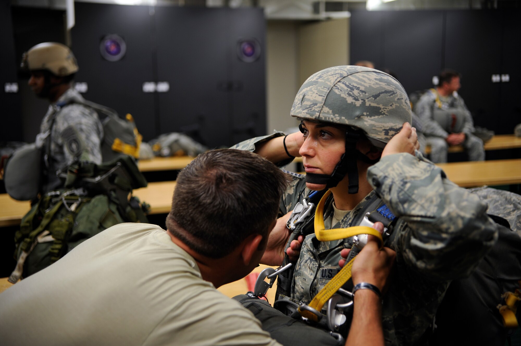 Staff Sgt. Christopher Bitwinski, Special Operations Command operational NCO, inspects the security of Tech. Sgt. Veronica Gatta’s, Joint Communications Support Element Direct Communications Support team chief, parachute gear May 21, 2014 at MacDill Air Force Base, Fla. This type of joint assignment is Gatta’s first in her career and has provided an extremely rare and motivating experience. (U.S. Air Force photo by Senior Airman Vernon L. Fowler Jr./Released)
