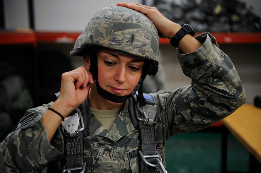 Tech. Sgt. Veronica Gatta, Joint Communications Support Element Direct Communications Support team chief, secures her helmet while gearing up for a parachute jump May 21, 2014 at MacDill Air Force Base, Florida. During her tenure, she has supported Operation Enduring Freedom and recently returned from a maritime deployment installing and operating command and control (C2) communications aboard a vessel since her time at JCSE. (U.S. Air Force photo/Senior Airman Vernon L. Fowler Jr.)