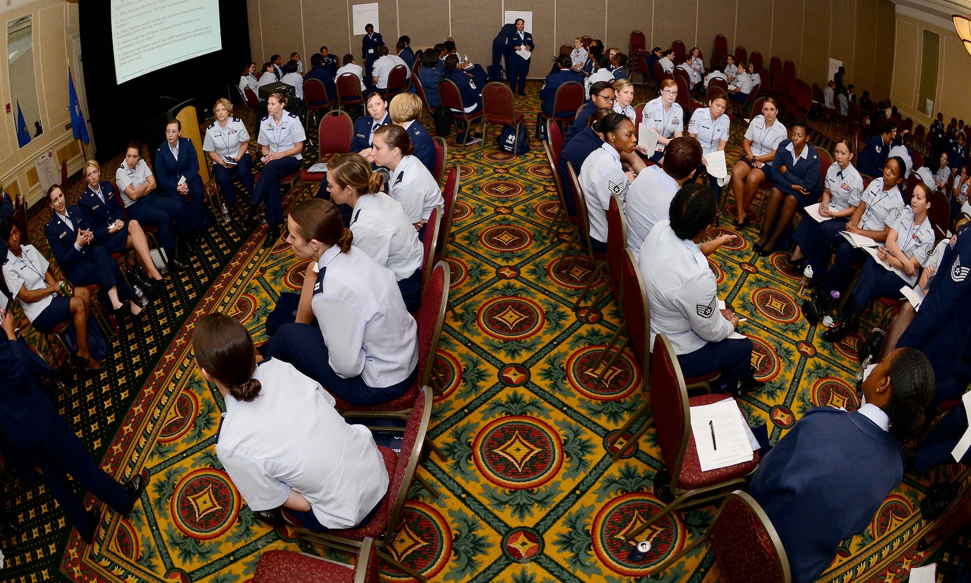 U.S. Air Force Airmen and international Service members participate in a small group discussion during the 27th Annual Joint Women’s Leadership Symposium in Norfolk, Va., June 13, 2014.  The discussion groups, titled “The Desire to Serve,” focused on women’s retention in the military. (U.S. Air Force photo by Staff Sgt. Antoinette Gibson/Released)