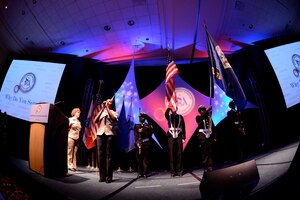 The Granby High School U.S. Navy all-female color guard presents the colors at the 27th Annual Joint Women’s Leadership Symposium in Norfolk, Va., June 12, 2014.  The symposium offered female Service members the opportunity for personal and professional development with a focus on the issues of retention, professional growth and reasons behind why women continue to serve. (U.S. Air Force photo by Staff Sgt. Antoinette Gibson/Released)