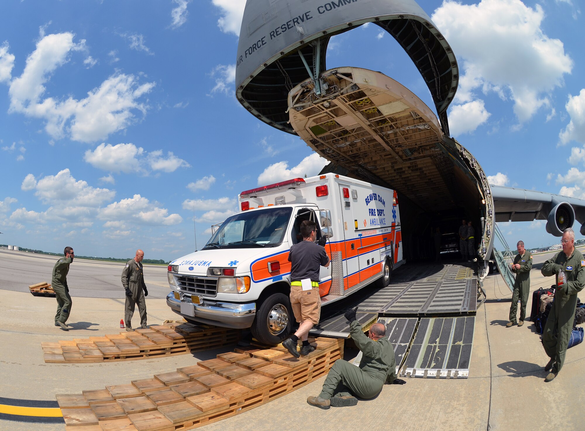 Airmen from the 337th Airlift Squadron load an ambulance and two fire trucks onto a Westover C-5, at Joint Base Charleston, SC, June 9. This Denton Amendment mission delivered the vehicles to Managua, Nicaragua June 10 on behalf of the Wisconsin/Nicaragua Partners of the Americas Incorporated. (U.S. Air Force photo/SSgt. Kelly Goonan)