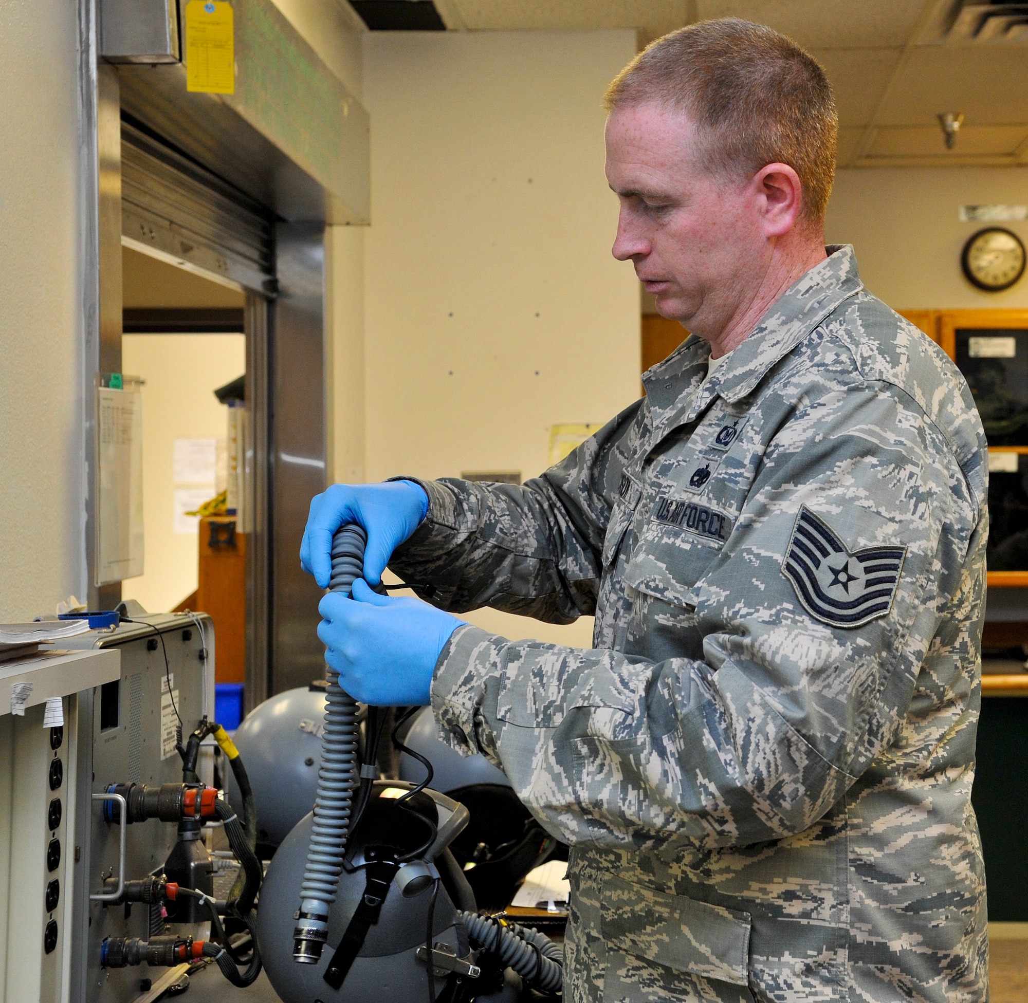 Tech. Sgt. Bryan Dickson, 56th Operation Support Squadron aircrew flight equipment NCO in charge, works on a Mbu-ZO/P oxygen hose May 29 at Luke Air Force Base. The 56th OSS AFE Airmen clean, inspect and reassemble several pieces of equipment to ensure serviceability and safety for the pilots. (U.S. Air Force photo/Airman 1st Class Cory Gossett)
