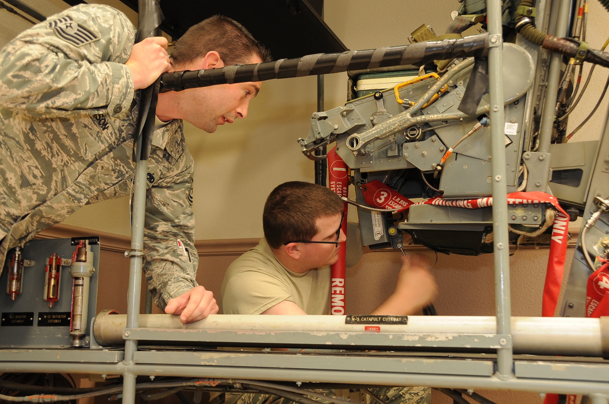 Tech. Sgt. Troy Addison, 372nd Training Squadron Field Training Detachment 205 egress instructor, watches as a student performs a maintenance task on a B-52H Stratofortress ejection seat at Barksdale Air Force Base, La., June 9, 2014. FTD teaches maintenance personnel a combination of basic theory, hands-on wrench turning and troubleshooting. (U.S. Air Force photo/Staff Sgt. Jason McCasland)