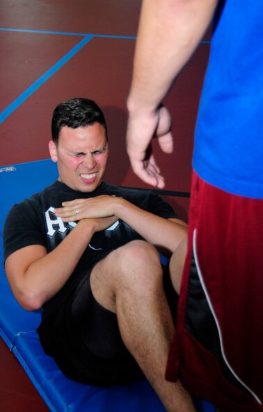 U.S. Air Force Senior Airman Jorge Robles, 100th Maintenance Squadron repair and reclamation journeyman from Pasadena, Calif., pushes out 75 situps in a minute during the Mad Marauder Fitness Challenge at the Marauder Melee June 13, 2014, on RAF Mildenhall, England. The Marauder Melee is an annual sports day promoting espirit de corps amongst units on base. (U.S. Air Force photo/Karen Abeyasekere/Released)