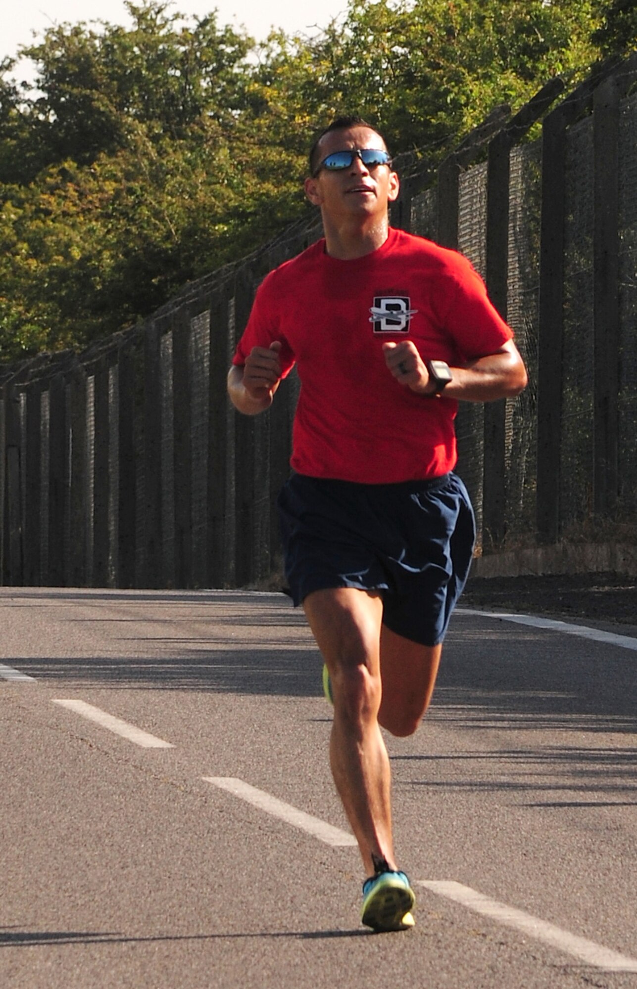 U.S. Air Force Senior Master Sgt. Cesar Flores, 351st Air Refueling Squadron superintendent from Fort Worth, Texas, completes a 5 km run during the opening event of the Marauder Melee June 13, 2014, on RAF Mildenhall, England. Flores won first place with a finishing time of 17:18. (U.S. Air Force photo/Staff Sgt. Rachel Waller/Released)
