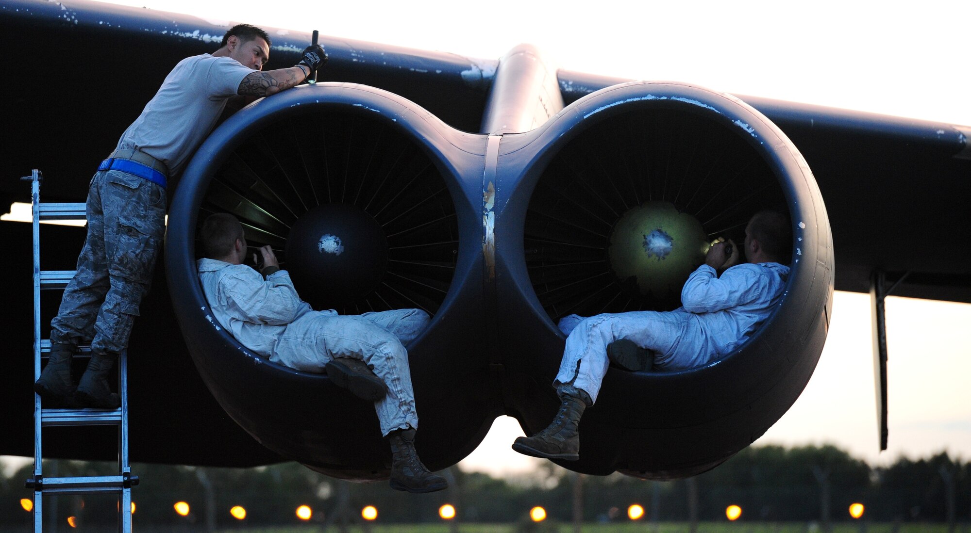 Staff Sgt. Randy Guijo, 5th Aircraft Maintenance Squadron dedicated crew chief, Minot Air Force Base, N.D., performs maintenance on the engine bays of a B-52 Stratofortress at RAF Fairford, England, June 11, 2014, alongside Staff Sgt. Matthew Washburn and Staff Sgt. Joshua Sauer, 2nd Aircraft Maintenance Squadron dedicated crew chiefs, Barksdale Air Force Base, La. Airmen from Minot and Barksdale deployed to the U.S. European Command area of operations to train and integrate with U.S. and allied military forces in the region. (U.S. Air Force photo by Staff Sgt. Nick Wilson/Released)