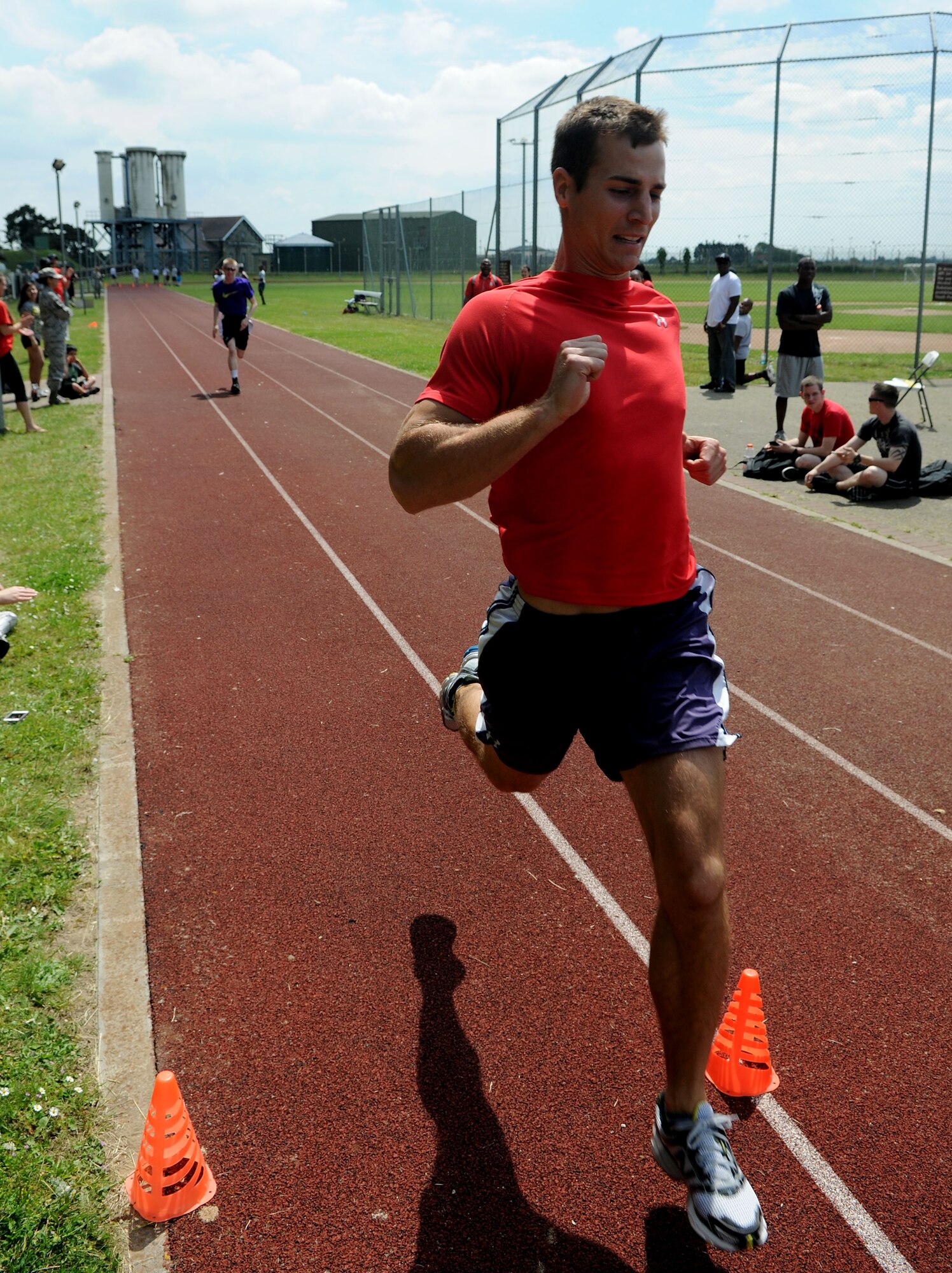 U.S. Air Force 1st Lt. Robert Allen, 351st Air Refueling Squadron KC-135 Stratotanker copilot from Newport, N.C., sprints through the finish line of a 100-meter race during the Marauder Melee June 13, 2014, at the Heritage Park track on RAF Mildenhall, England. The Marauder Melee is an annual sports day promoting espirit de corps amongst units on base. (U.S. Air Force photo/Senior Airman Kate Maurer/Released)
