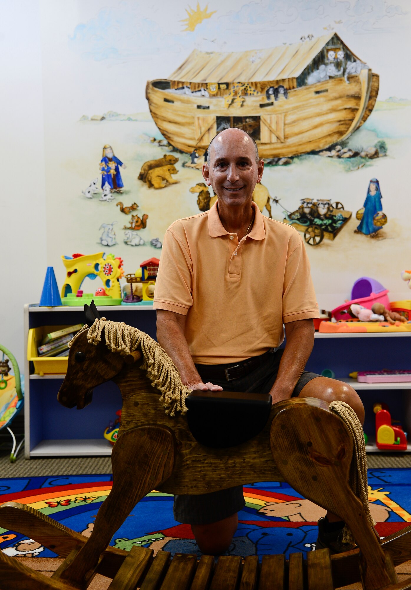 Steve Angelozzi, retired federal Department of Defense employee, poses with the rocking horse he donated to the base chapel at MacDill Air Force Base, Fla., June 12, 2014. Angelozzi donated the rocking horse on behalf of former President George W. and First Lady Bush. (U.S. Air Force photo by Senior Airman Vernon L. Fowler Jr./Released)