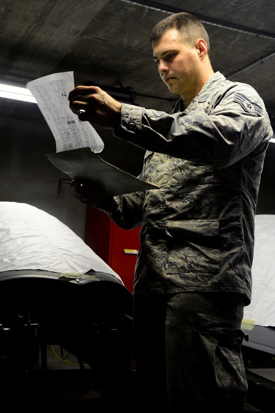 United States Air Force Staff Sgt. William Harth, 1st Maintenance Squadron Aircrew Egress craftsman, completes an inspection checklist at Langley Air Force Base, Va., June 9, 2014. Egress Airmen ensure all components responsible for safely ejecting a pilot work properly and work more than 1,700 explosives in the egress systems. (U.S. Air Force photo by Senior Airman Kayla Newman/Released) 