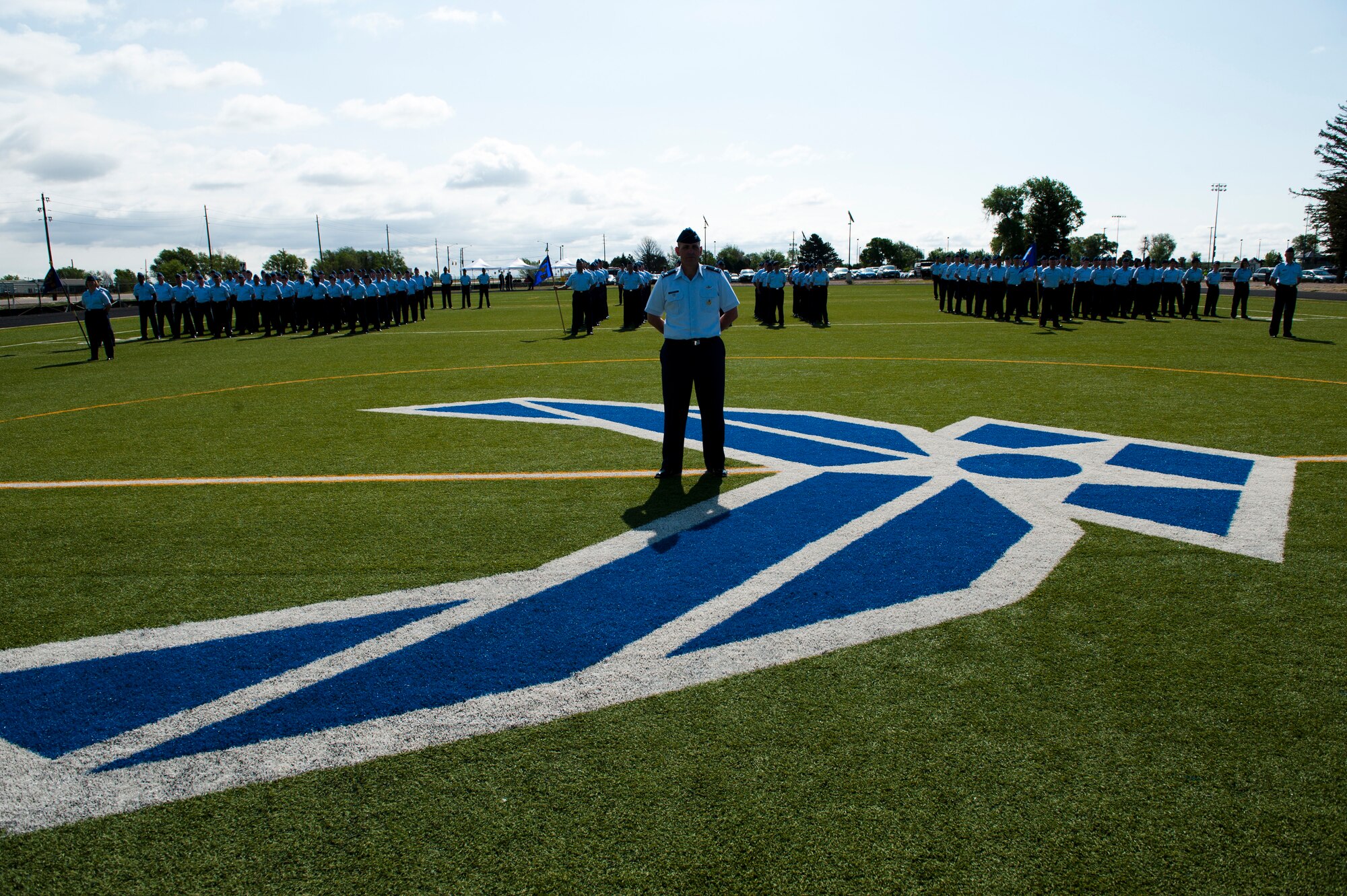 Members of the 460th Space Wing stand at ease during the 460th Space Wing Change of Command Ceremony June 12, 2014, at the all-purpose field on Buckley Air Force Base, Colo. The event signals Col. John Wagner, 460 SW commander, assumption of command from Col. Dan Wright. (U.S. Air Force photo by Senior Airman Phillip Houk/Released)