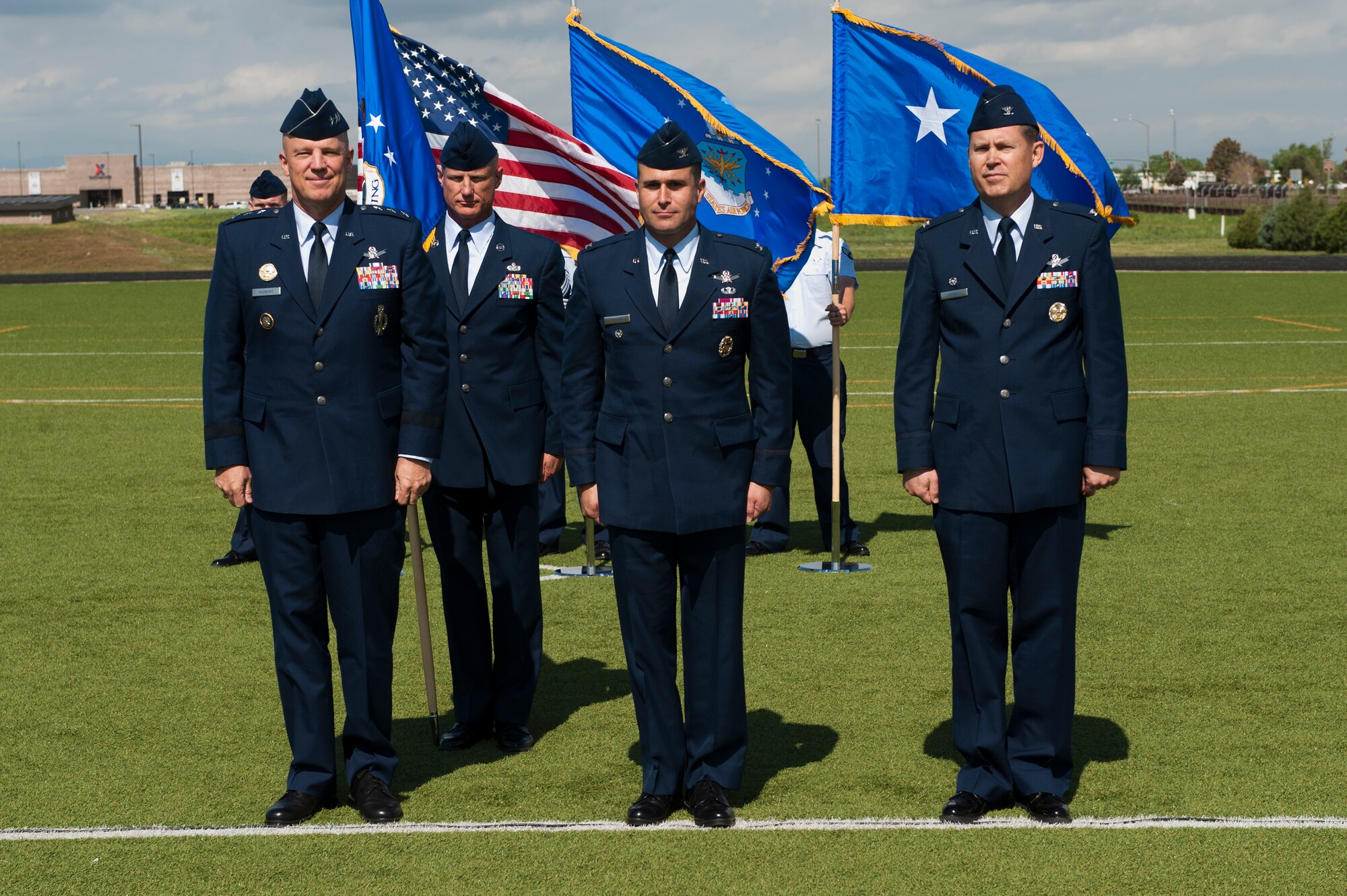 From left; Lt. Gen. John W. “Jay” Raymond, U.S. Strategic Command's Joint Functional Component Command for Space and 14th Air Force (Air Forces Strategic) commander; Chief Master Sgt. Craig S. Hall, 460th Space Wing command chief, Col. John Wagner, 460th SW commander; and Col. Dan Wright stand together during the presentation of Wagner as the new commander of the 460th Space Wing during the change of command ceremony June 12, 2014, at the all-purpose field on Buckley Air Force Base, Colo. This event signals Wagner’s assumption of command from Wright, who assumed command June 2013. (U.S. Air Force photo by Senior Airman Phillip Houk/Released)