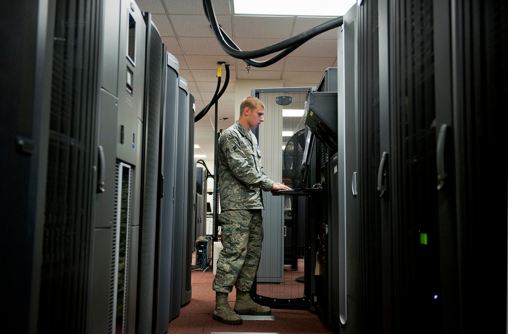 Airman 1st Class Nick Fazio, with the Network Operations, verifies the status and configuration of the 96th Communications Squadron’s data center equipment at Eglin Air Force Base, Fla., June 9.  Approximately 40 Airmen and civilians are responsible for the connectivity of the base’s more than 19,500 user workcenters on base.  Their contributions combined with the other branches and flights led to the 96th CS earning the 2013 Maj. Gen. Harold McClelland best large communications work center award for Air Force Materiel Command.  (U.S. Air Force photo/Samuel King Jr.)