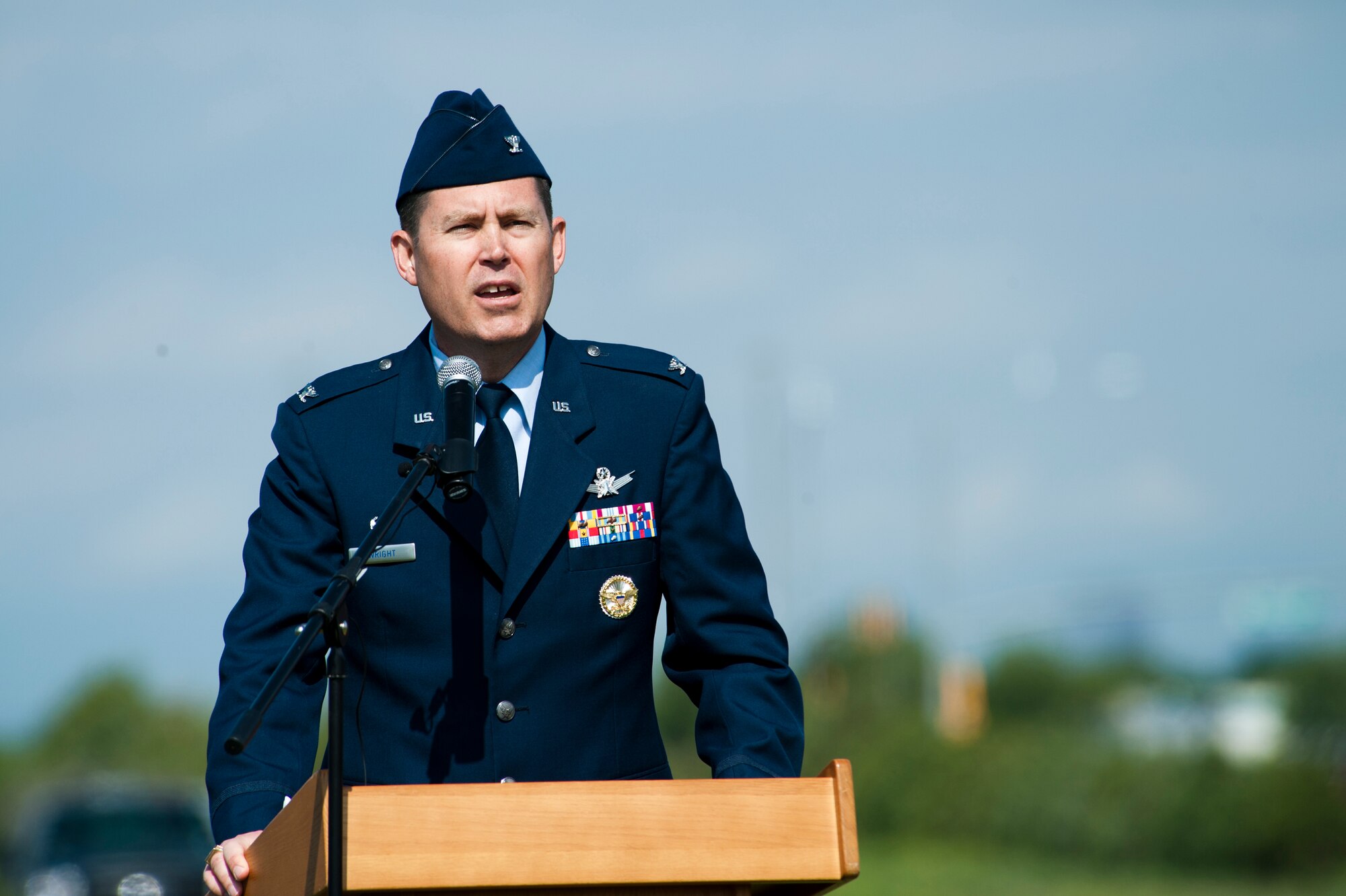Col. Dan Wright provides his final remarks before he relinquishes command of the 460th Space Wing during the change of command ceremony June 12, 2014, at the all-purpose field on Buckley Air Force Base, Colo. Wright served as the commander of the 460th SW since June 2013, where he lead the base through challenging fiscal times, several deaths, and began several actions to localize medical services. (U.S. Air Force photo by Senior Airman Phillip Houk/Released)