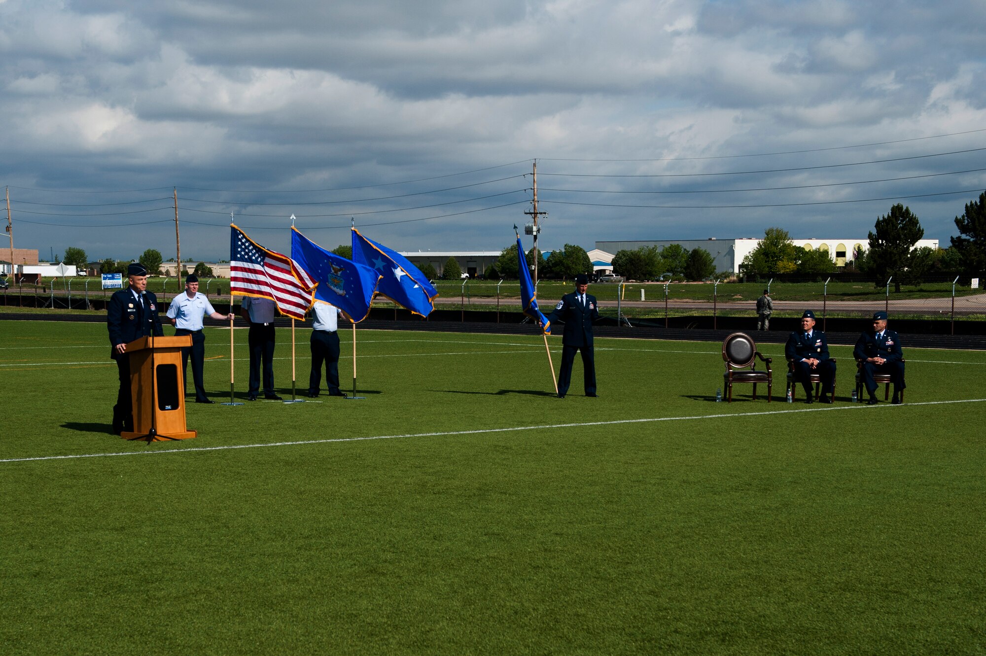 Lt. Gen. John W. “Jay” Raymond, U.S. Strategic Command's Joint Functional Component Command for Space and 14th Air Force (Air Forces Strategic) commander, left, provides the opening remarks during the 460th Space Wing Change of Command Ceremony June 12, 2014, at the all-purpose field on Buckley Air Force Base, Colo. The event signals Col. John Wagner, 460 SW commander, assumption of command from Col. Dan Wright. (U.S. Air Force photo by Senior Airman Phillip Houk/Released)