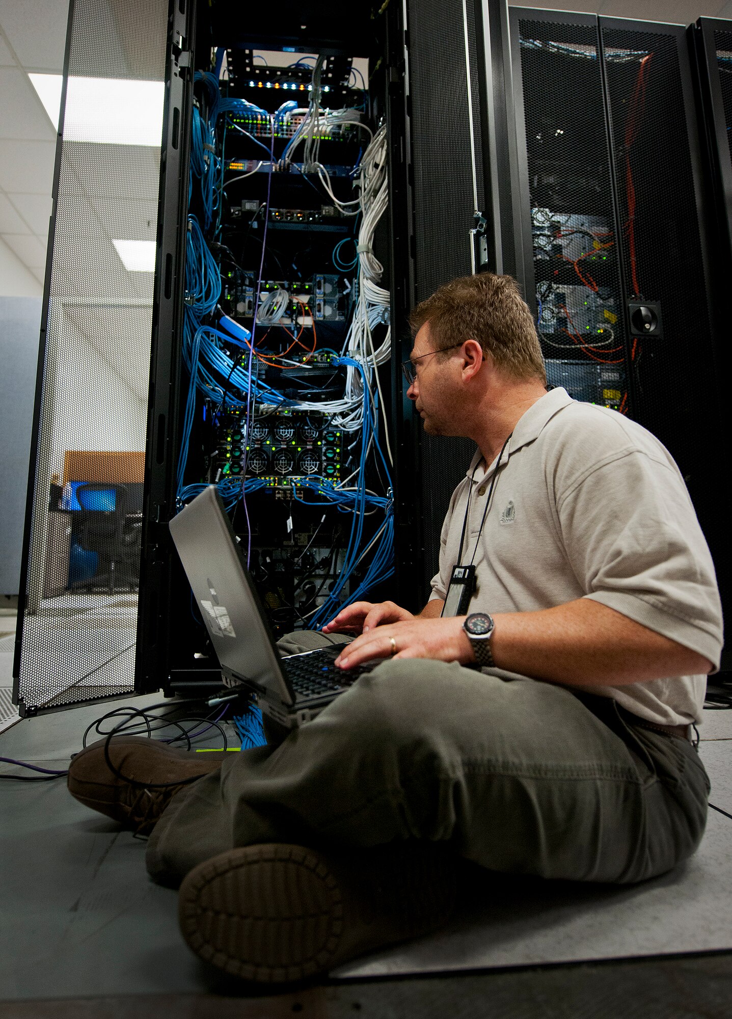 Kevin Dennis, a computer engineer with the Network Operations, verifies the status and configuration of the 96th Communications Squadron’s data center equipment at Eglin Air Force Base, Fla., June 9.  Approximately 40 Airmen and civilians are responsible for the connectivity of the base’s more than 19,500 user workcenters on base.  Their contributions combined with the other branches and flights led to the 96th CS earning the 2013 Maj. Gen. Harold McClelland best large communications work center award for Air Force Materiel Command.  (U.S. Air Force photo/Samuel King Jr.)
