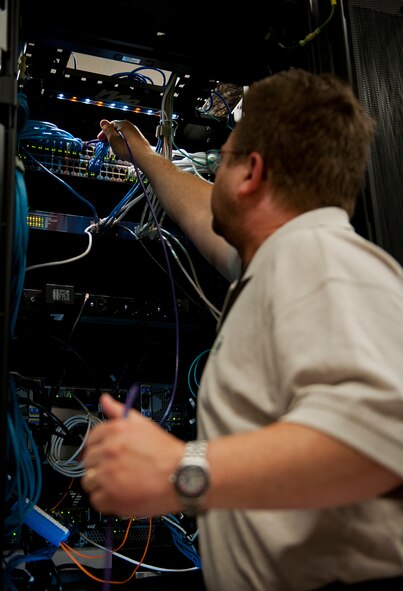 Kevin Dennis, a computer engineer with the Network Operations, troubleshoots the wiring on the 96th Communications Squadron’s data center equipment at Eglin Air Force Base, Fla., June 9.  Approximately 40 Airmen and civilians are responsible for the connectivity of the base’s more than 19,500 user workcenters on base.  Their contributions combined with the other branches and flights led to the 96th CS earning the 2013 Maj. Gen. Harold McClelland best large communications work center award for Air Force Materiel Command.  (U.S. Air Force photo/Samuel King Jr.)