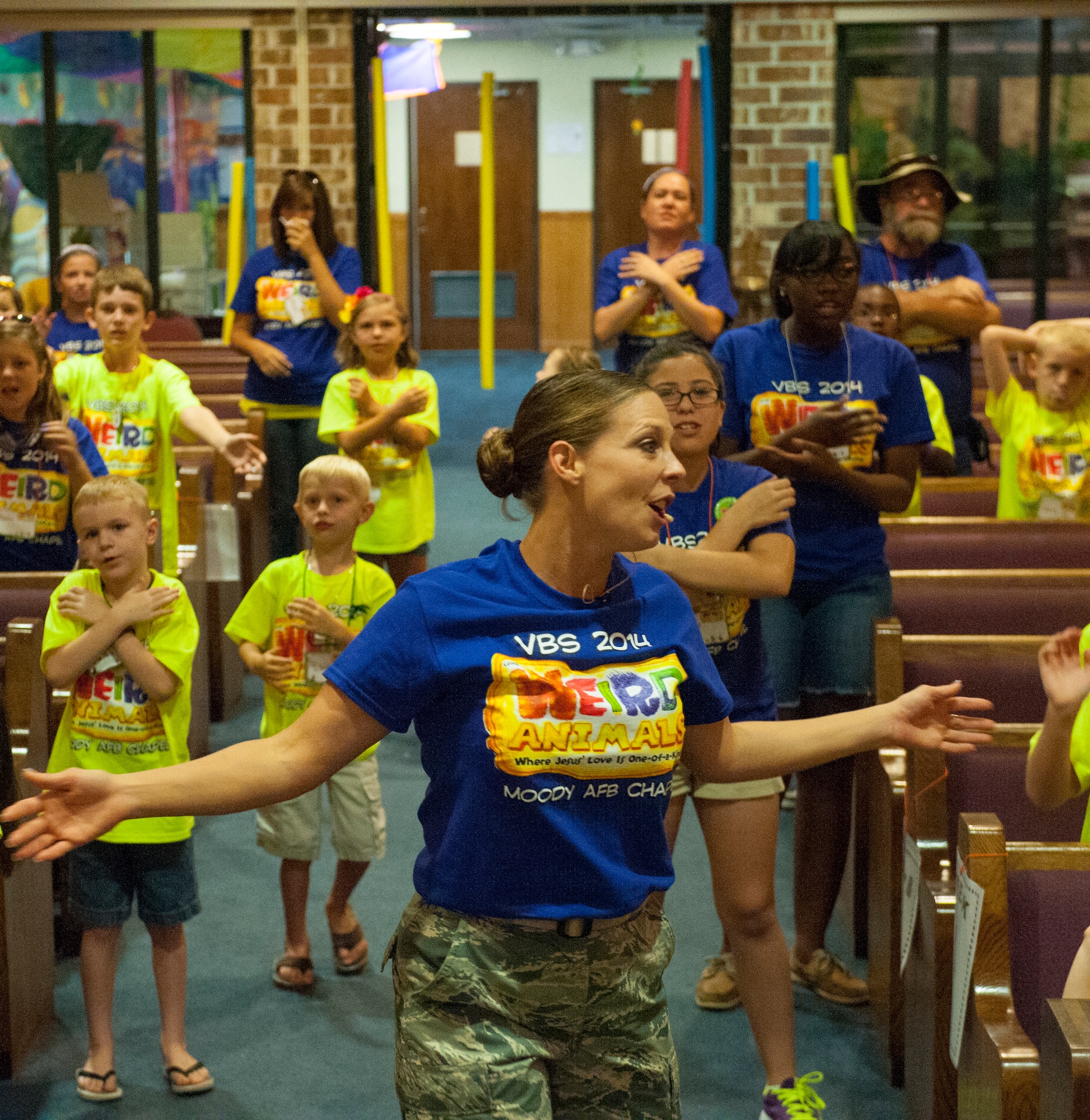 U.S. Air Force Tech. Sgt. Jessica Gramlick, 23d Wing chaplain assistant, performs for the children to start their day at Vacation Bible School (VBS) at Moody Air Force Base, Ga., June 11, 2014. The theme for this year’s VBS is weird animals.(U.S. Air Force photo by Airman 1st Class Ceaira Tinsley/Released)
