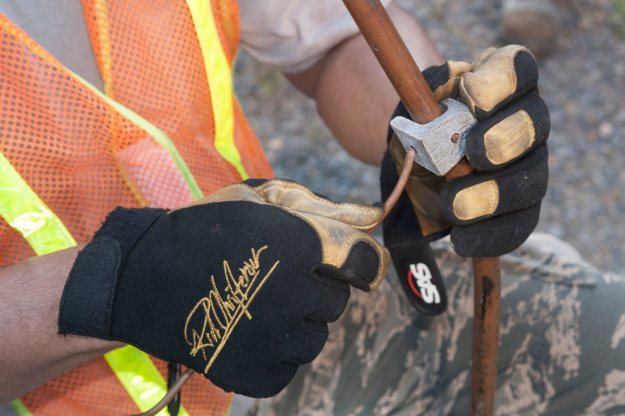 U.S. Air Force Senior Airman Doniel Kidd, a morale, welfare, recreational and services specialist assigned to the 307th Force Support Squadron, connects a ground wire for a generator fuel source at Barksdale Air Force Base, La., June 8, 2014. The ground wire keeps unexpected electrical charges from igniting the fuel source while the Airmen are completing annual combat readiness training. (U.S. Air Force photo by Master Sgt. Jeff Walston) 