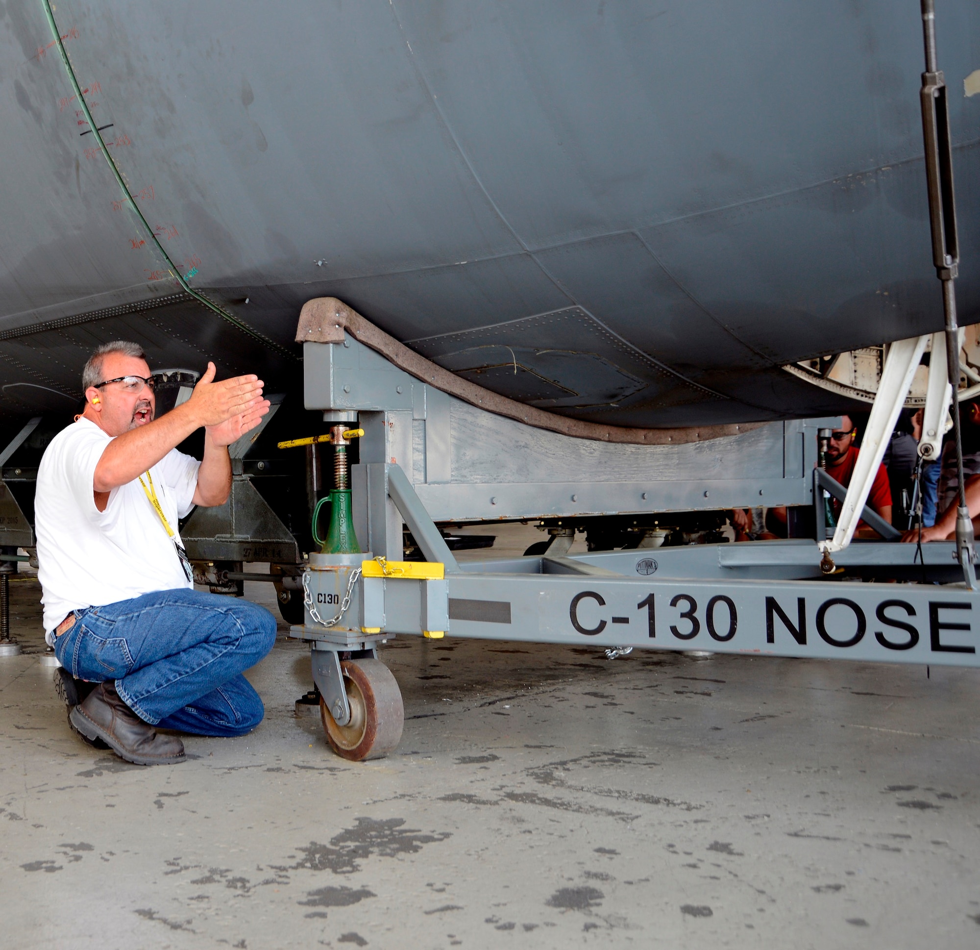 Jeff Price, 560th Aircraft Maintenance Squadron first line supervisor, directs his maintenance crew Wednesday during the mating of the two C-130 H sections. (U.S. Air Force photo by Ed Aspera)

