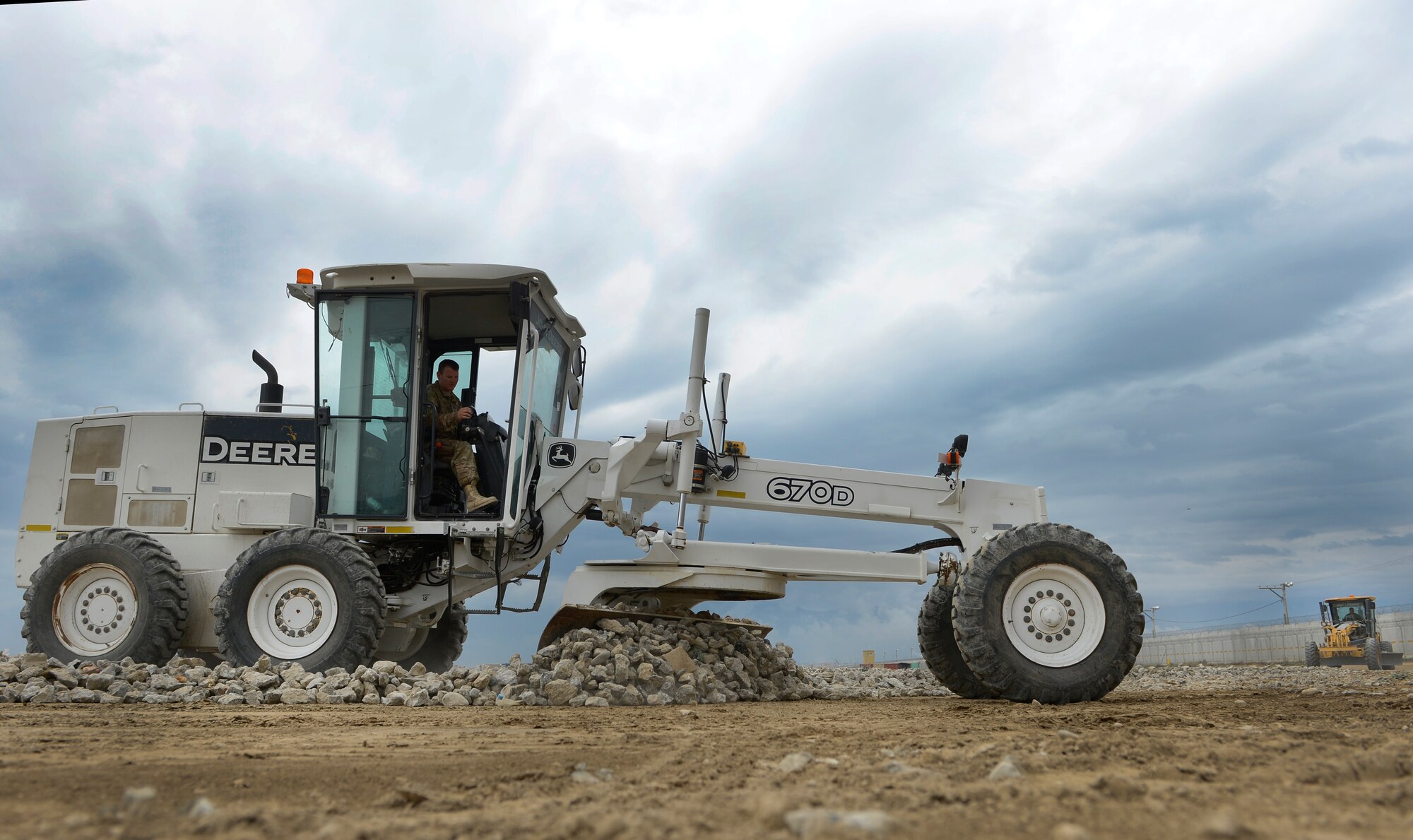 U.S. Air Force Staff Sgt. Joshua McCord, 577th Expeditionary Prime Base Engineer Emergency Force Squadron troop construction bravo, grades the Hickory Landing Zone at Bagram Air Base, Afghanistan, May 17, 2014. The new landing zone will comprise 166 thousand square feet of airfield matting. McCord is deployed from the 355th Civil Engineer Squadron Davis-Monthan Air Force Base, Arizona. (U.S. Air Force photo by Senior Airman Sandra Welch) 